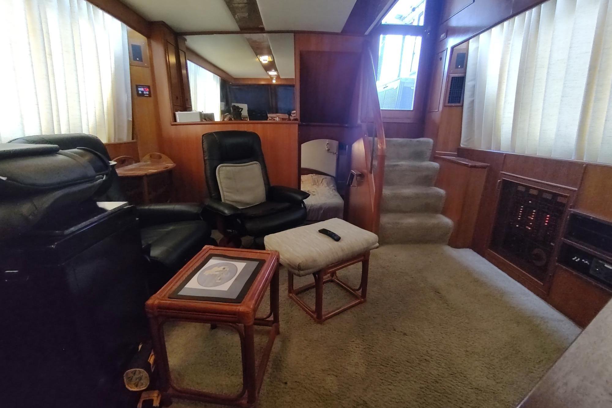 Interior of 1989 Hyatt Double Cabin Motoryacht with cozy seating and elegant wood paneling.