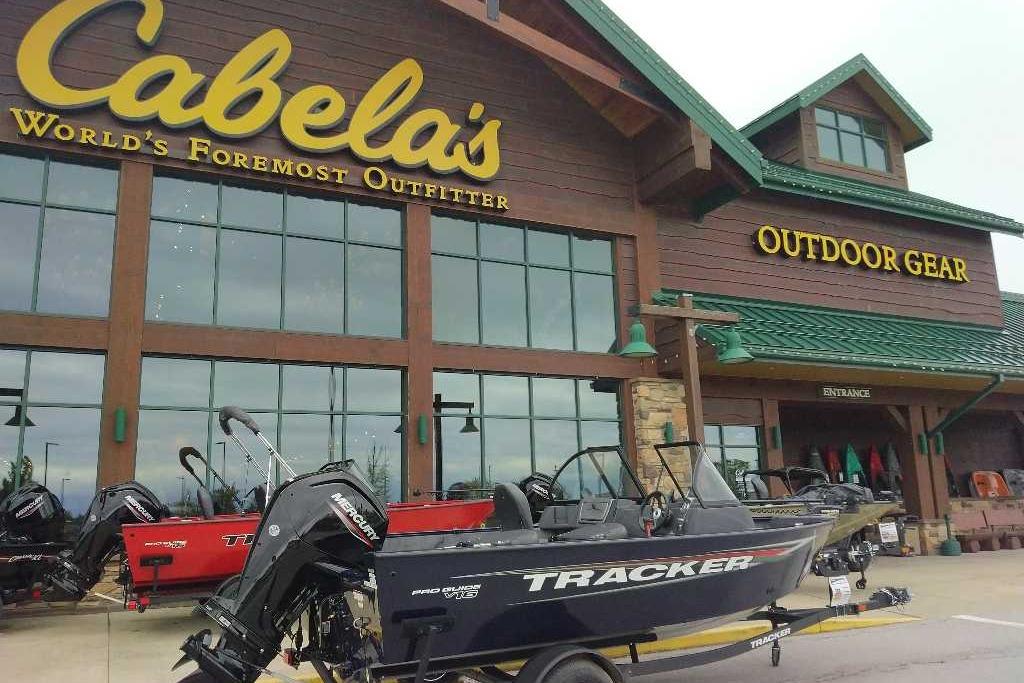 2026 Tracker Pro Guide V-16 WT boat displayed outside Cabela's outdoor gear store.