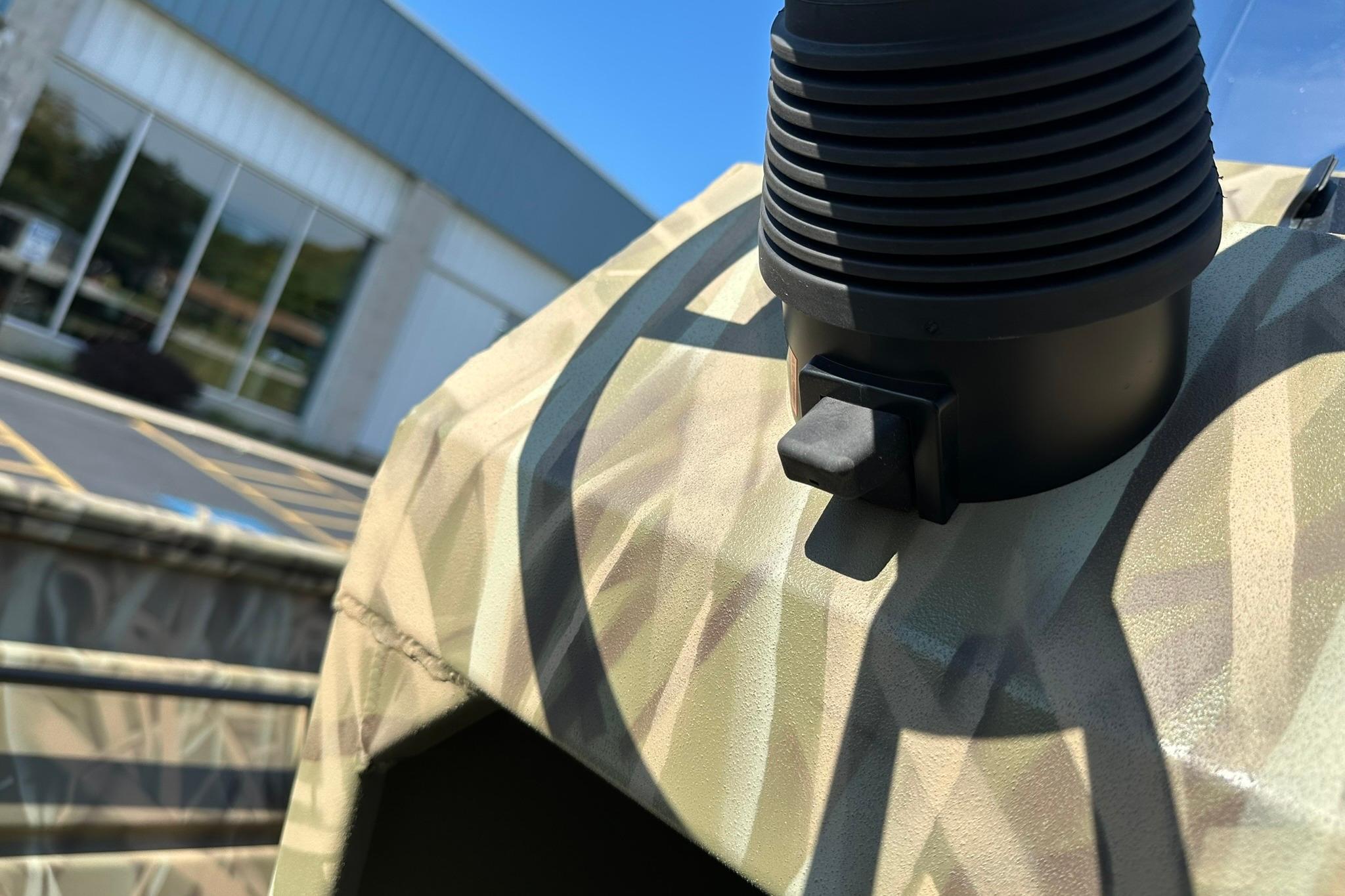 Close-up of 2026 Lowe Roughneck 2070CC boat detail with camouflage pattern.