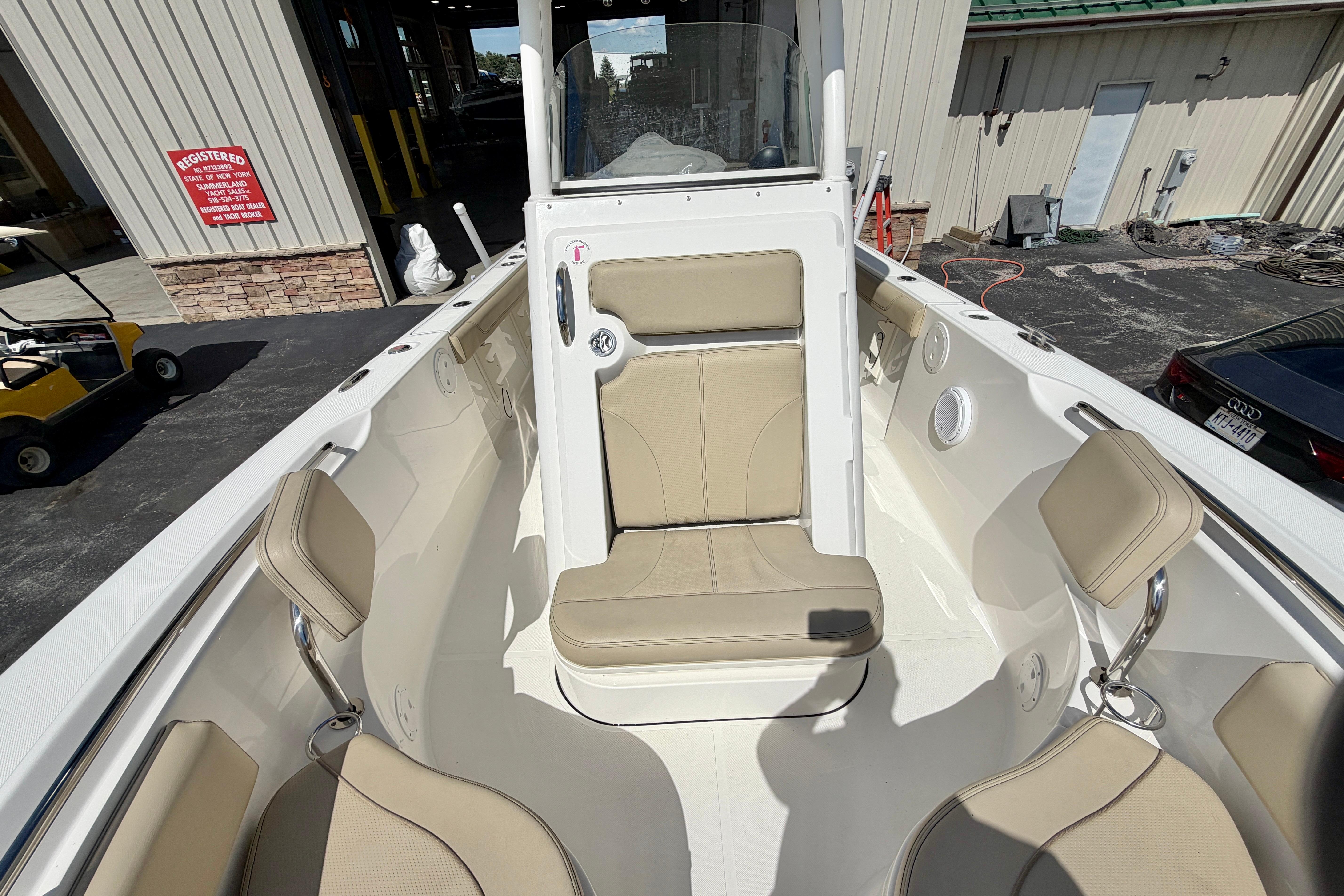 2020 Pursuit C 238 Center Console boat interior with beige seating and white deck.