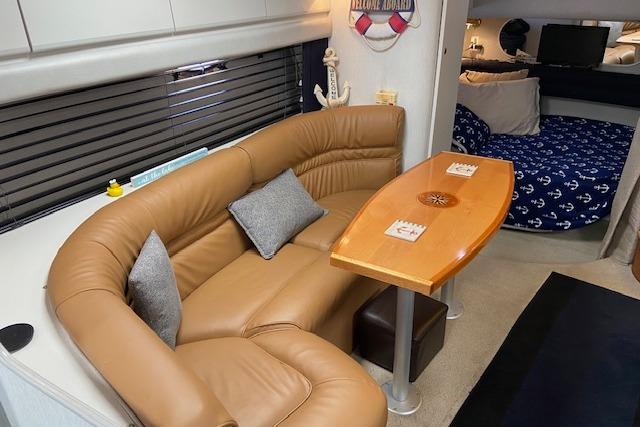 Interior of 1994 Cruisers Yachts 3675 Esprit with leather seating and wooden table.