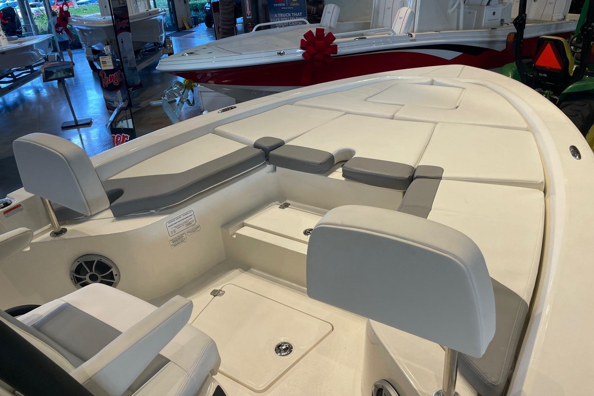 2026 Mako 24 APEX boat interior with cushioned seating and storage compartments.