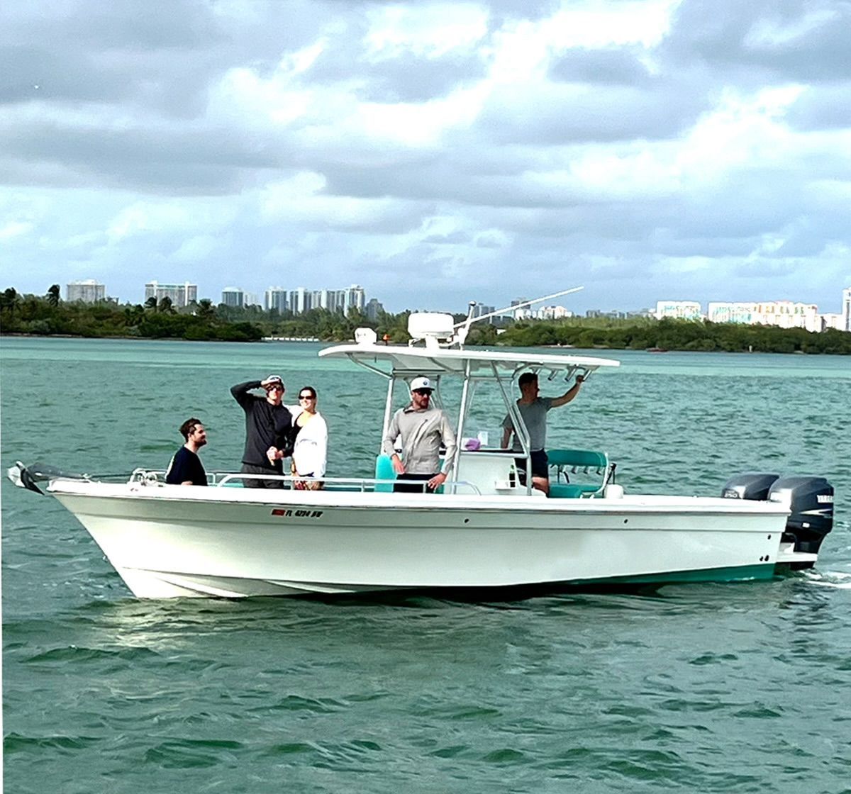 A group of people on a white boat on the water.