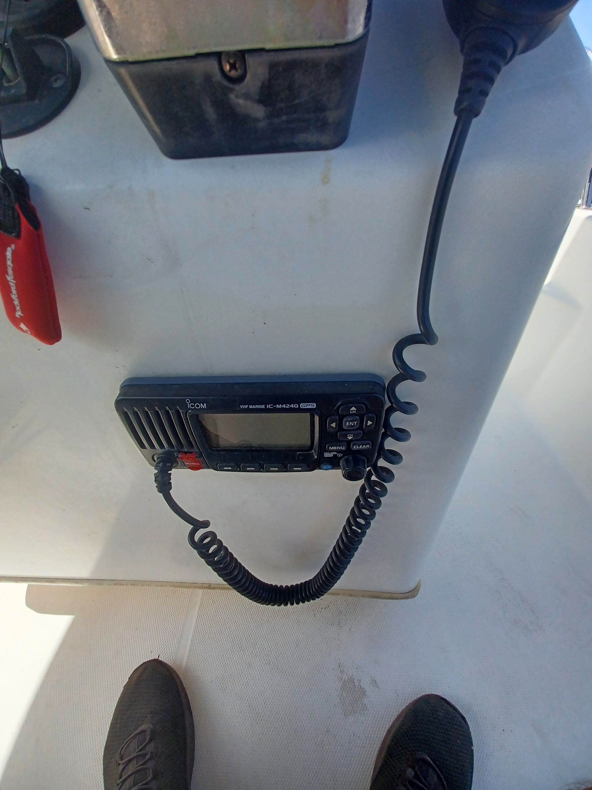 A radio is mounted on the console of a boat.