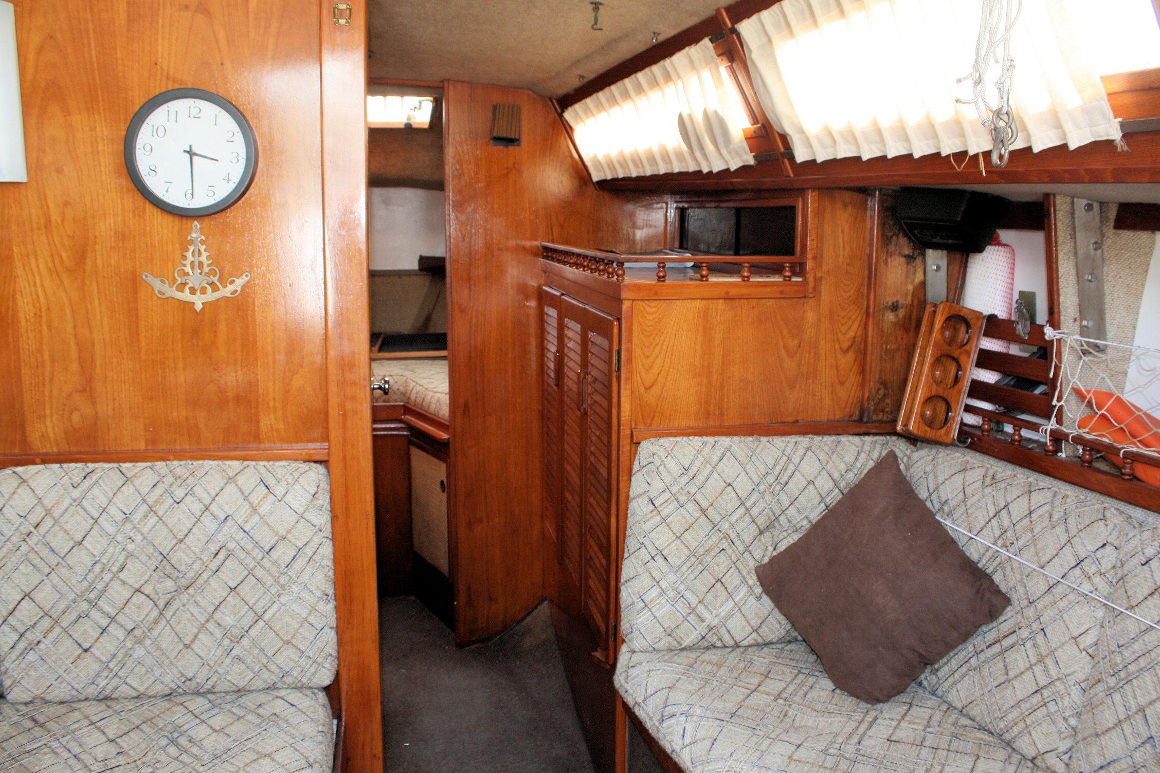 Interior of 1981 S2 9.2A sailboat with wooden paneling and cushioned seating.