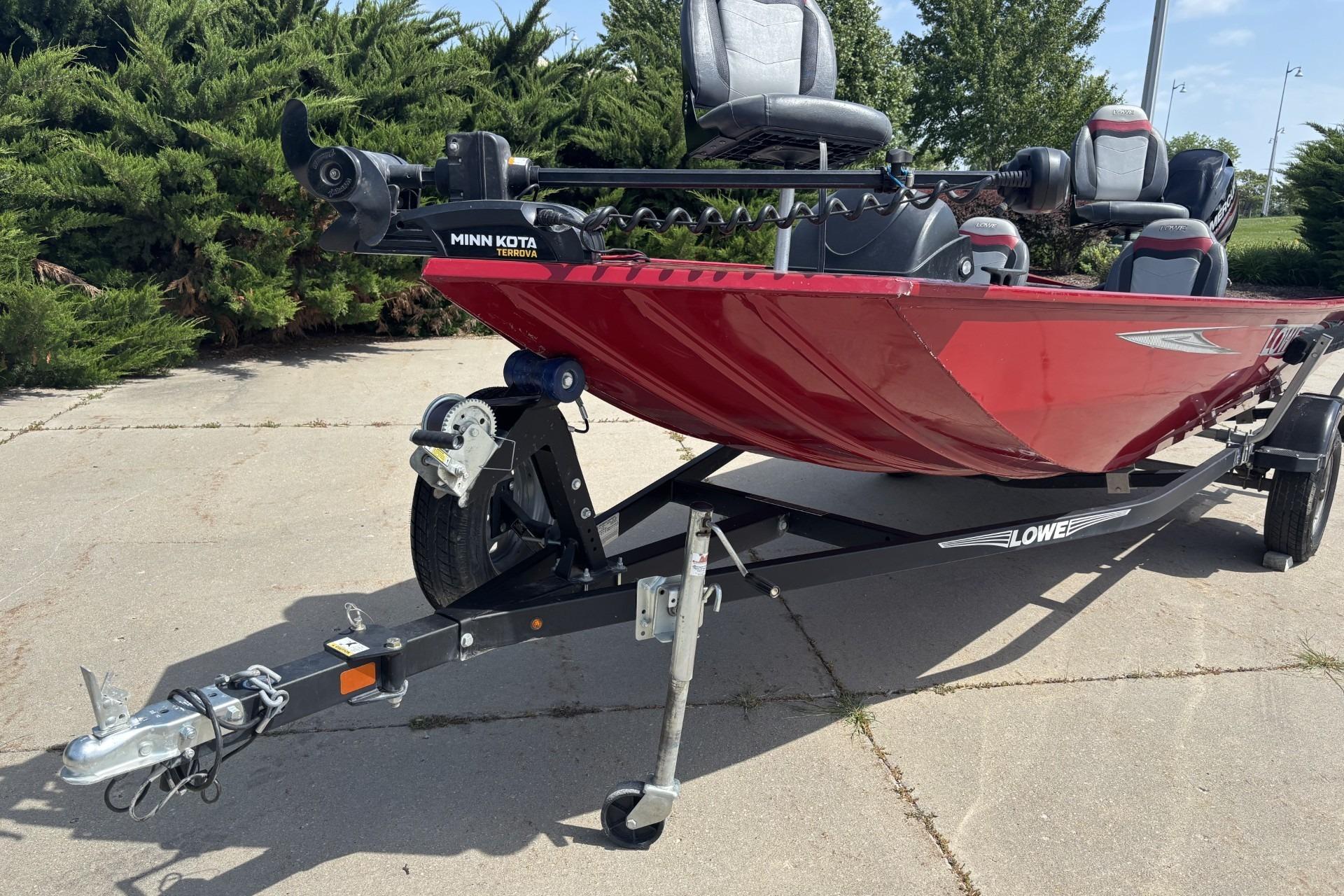 2019 Lowe Skorpion 17 boat with Minn Kota motor on trailer, parked outdoors.