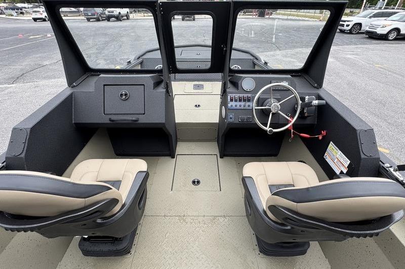 Interior view of 2026 SeaArk Predator 300 AK boat with dual seats and steering console.