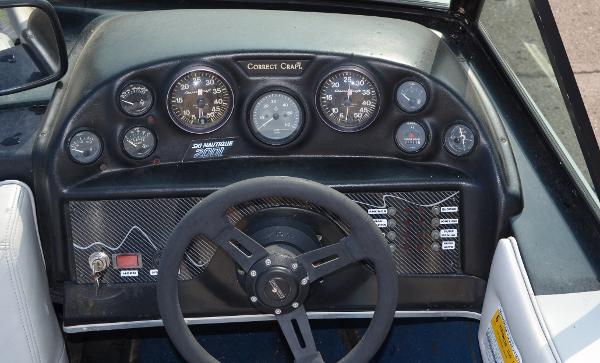 1989 Correct Craft Ski Nautique dashboard with gauges and steering wheel.