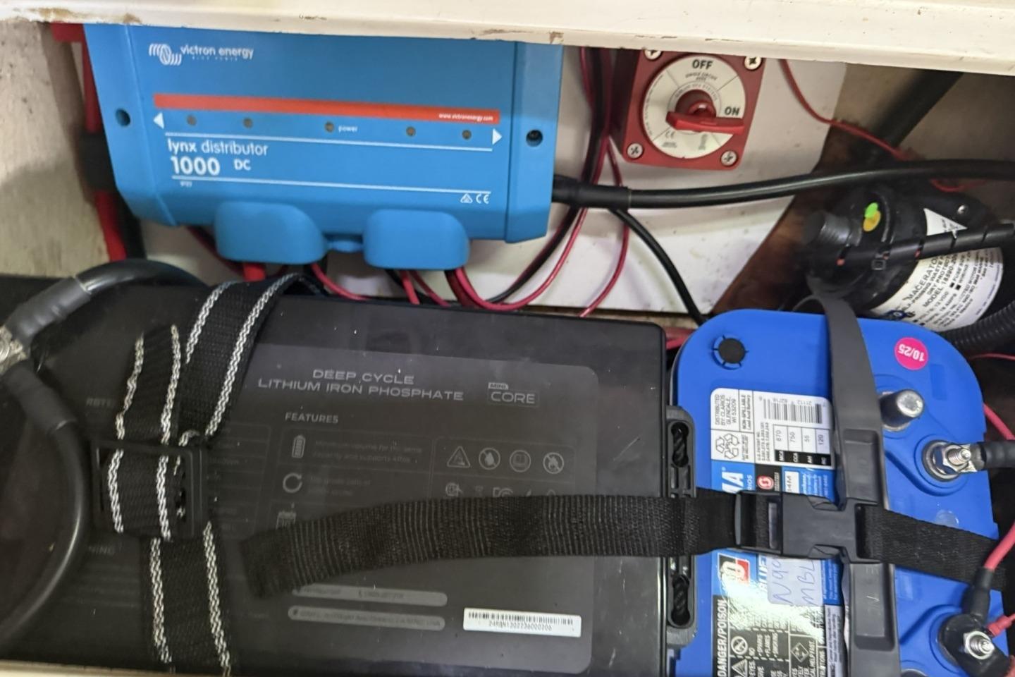 Electrical setup in a 1995 Catalina 320, featuring batteries and a Victron Energy Lynx distributor.