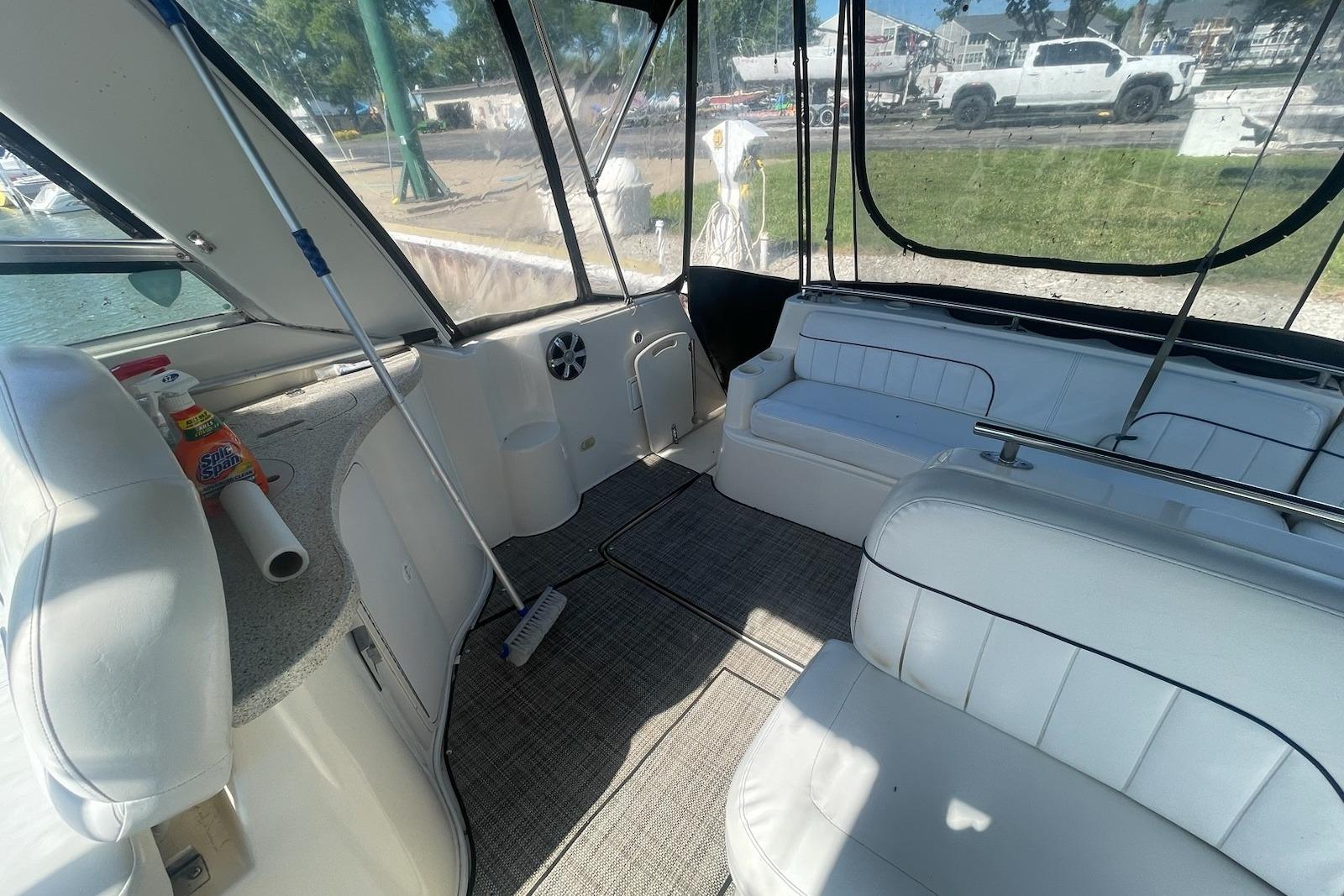Interior of 2000 Rinker Fiesta Vee 310 boat with white seating and clean design.
