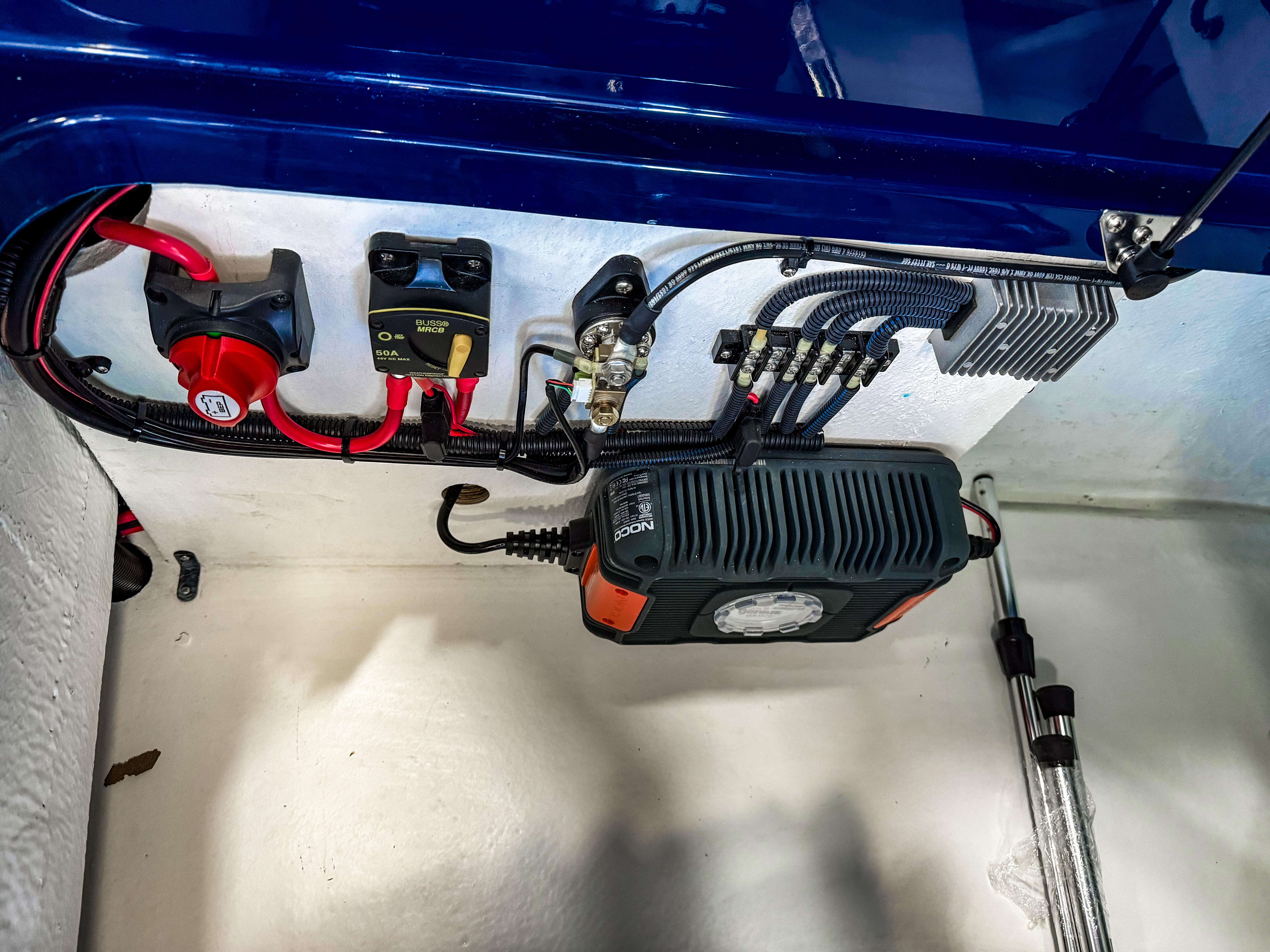 Electrical components inside Vision Marine Technologies Volt 180, 2025 model, showcasing wiring and connections.