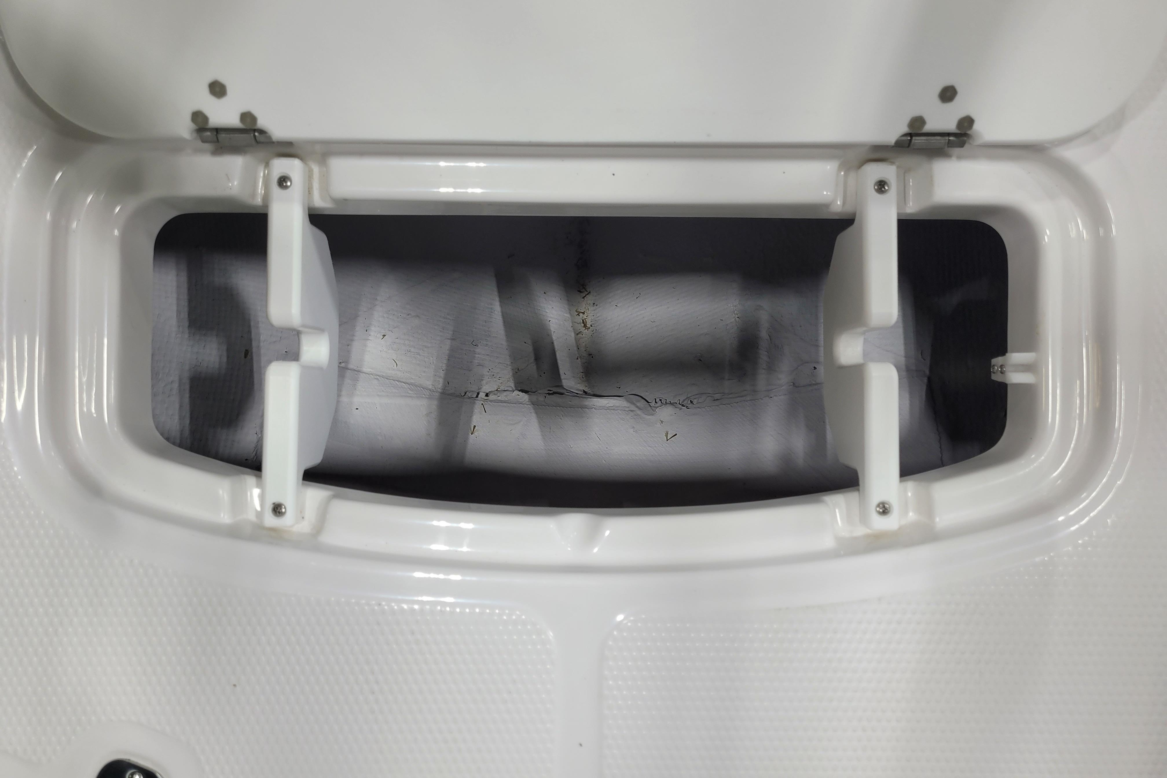 Open storage compartment on a 2026 Tahoe 2150 boat, showcasing interior details.