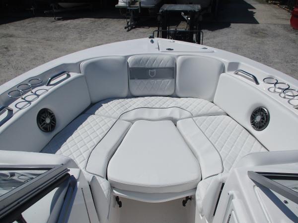 2025 Sea Fox 228 Traveler boat interior with white cushioned seating and cup holders.
