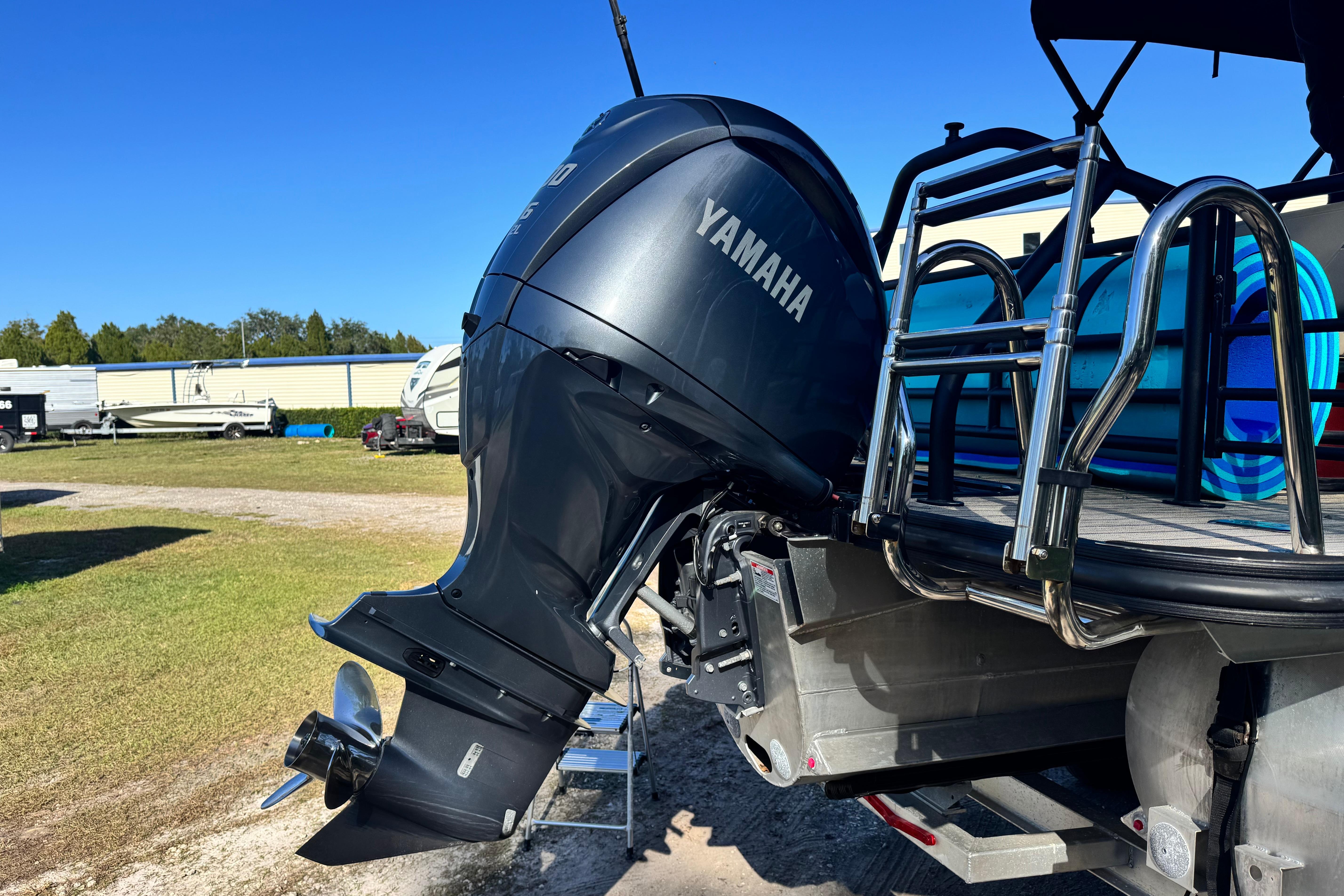 2023 Sylvan L5 CLZ boat with Yamaha outboard motor in a sunny outdoor setting.