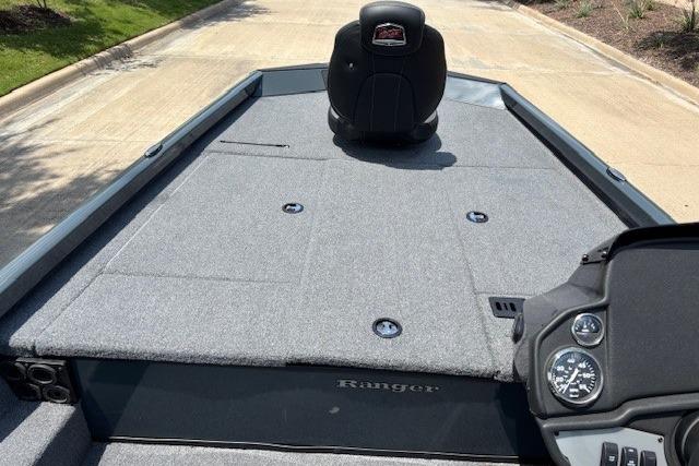 2026 Ranger RT188 boat interior with gray carpet and single seat on a sunny day.