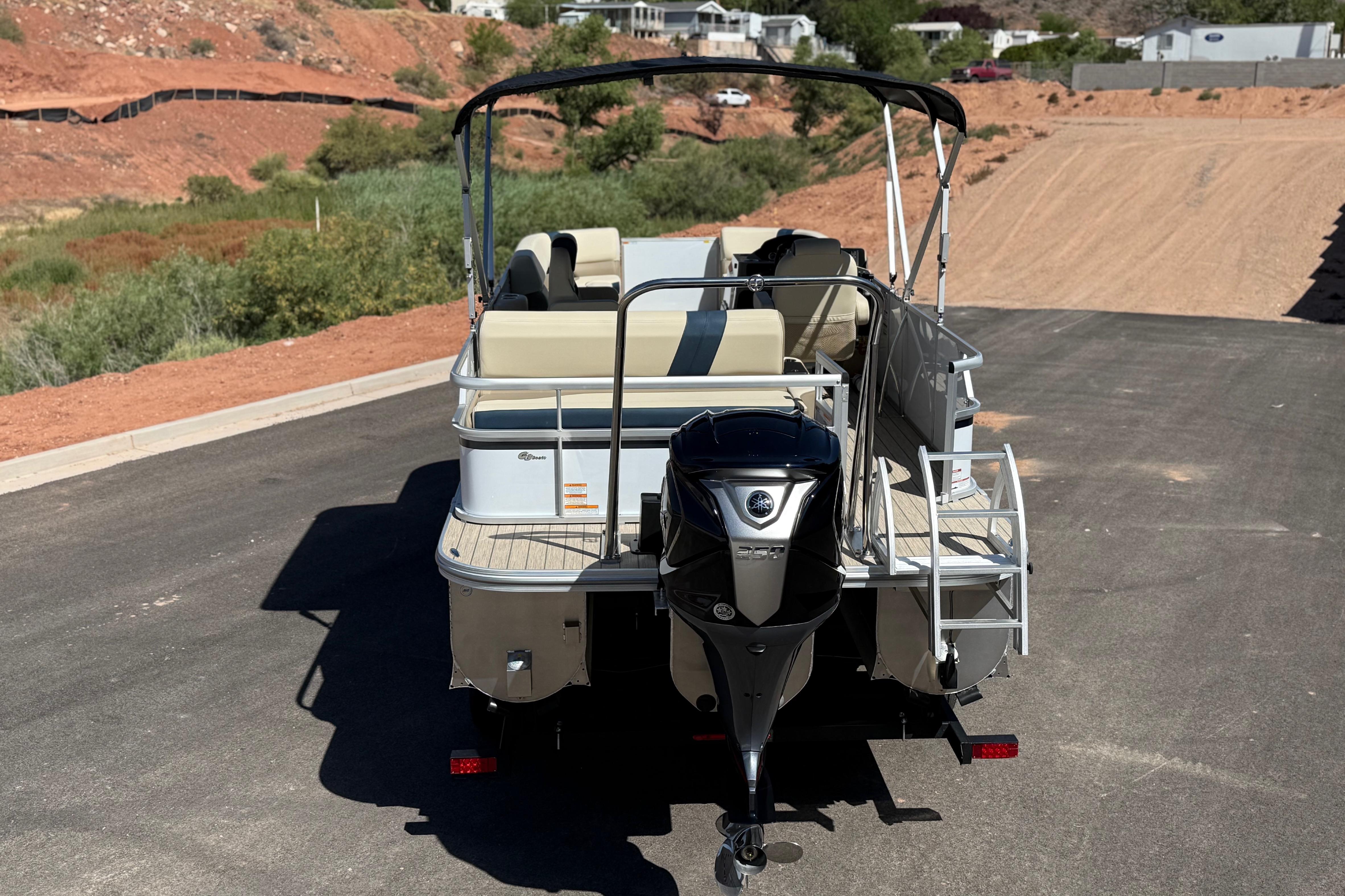 2026 SunCatcher Select 322SL pontoon boat on trailer, rear view, outdoor setting.
