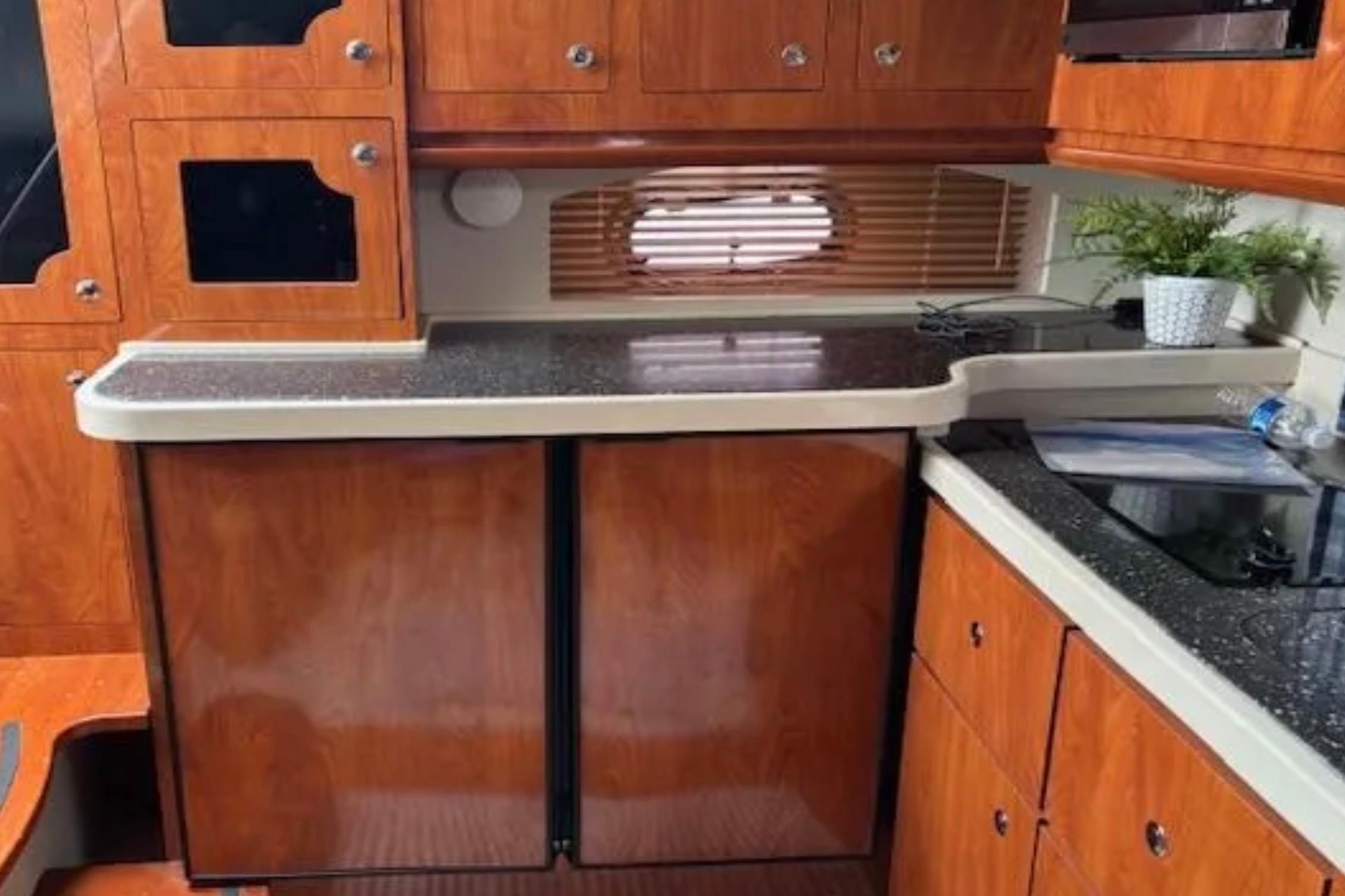 2007 Four Winns 378 Vista yacht interior with wooden cabinetry and countertop.