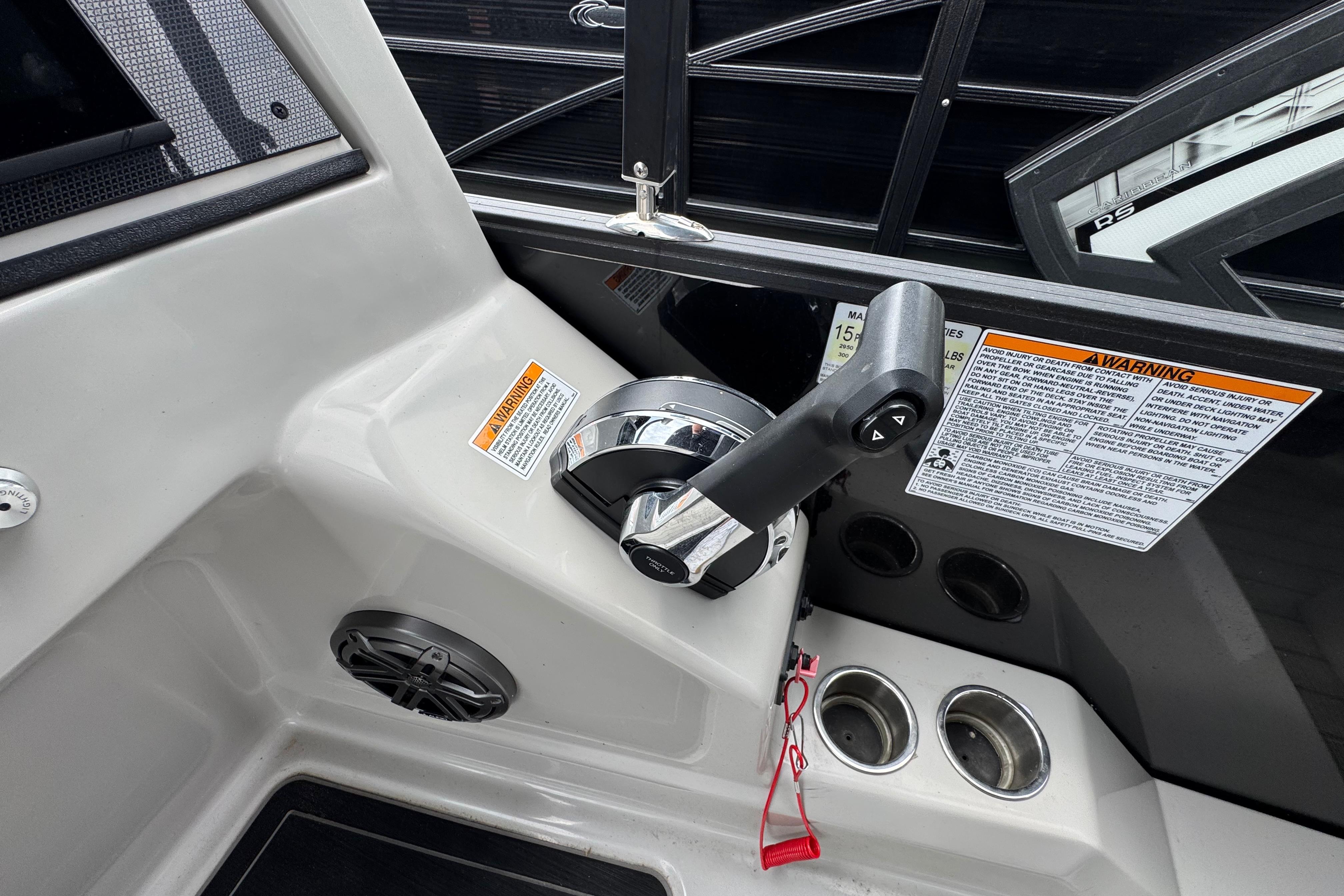 Control panel of 2023 Starcraft MX 25 DL DH boat with throttle and warning labels.