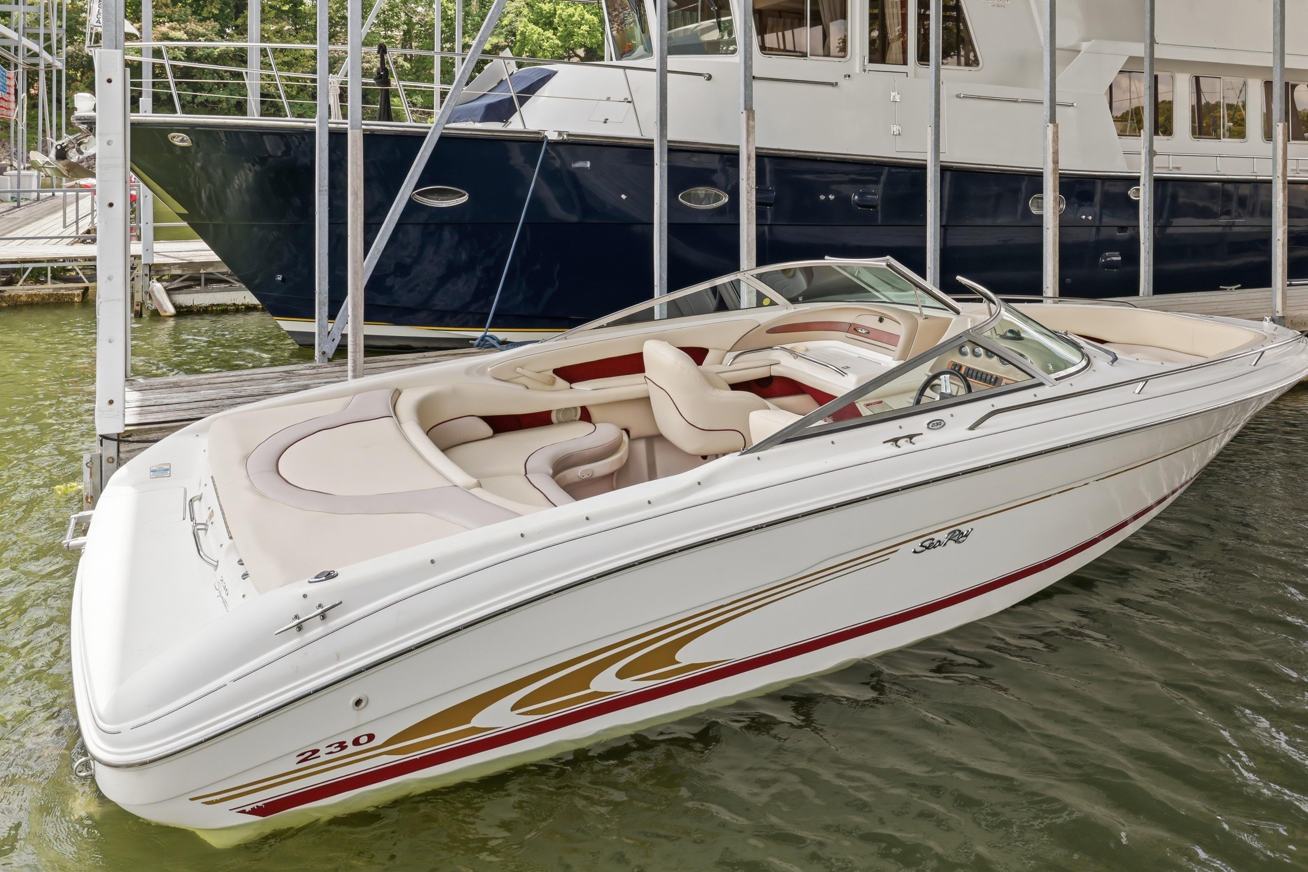 1997 Sea Ray 230 Signature boat docked, featuring sleek design and spacious seating.