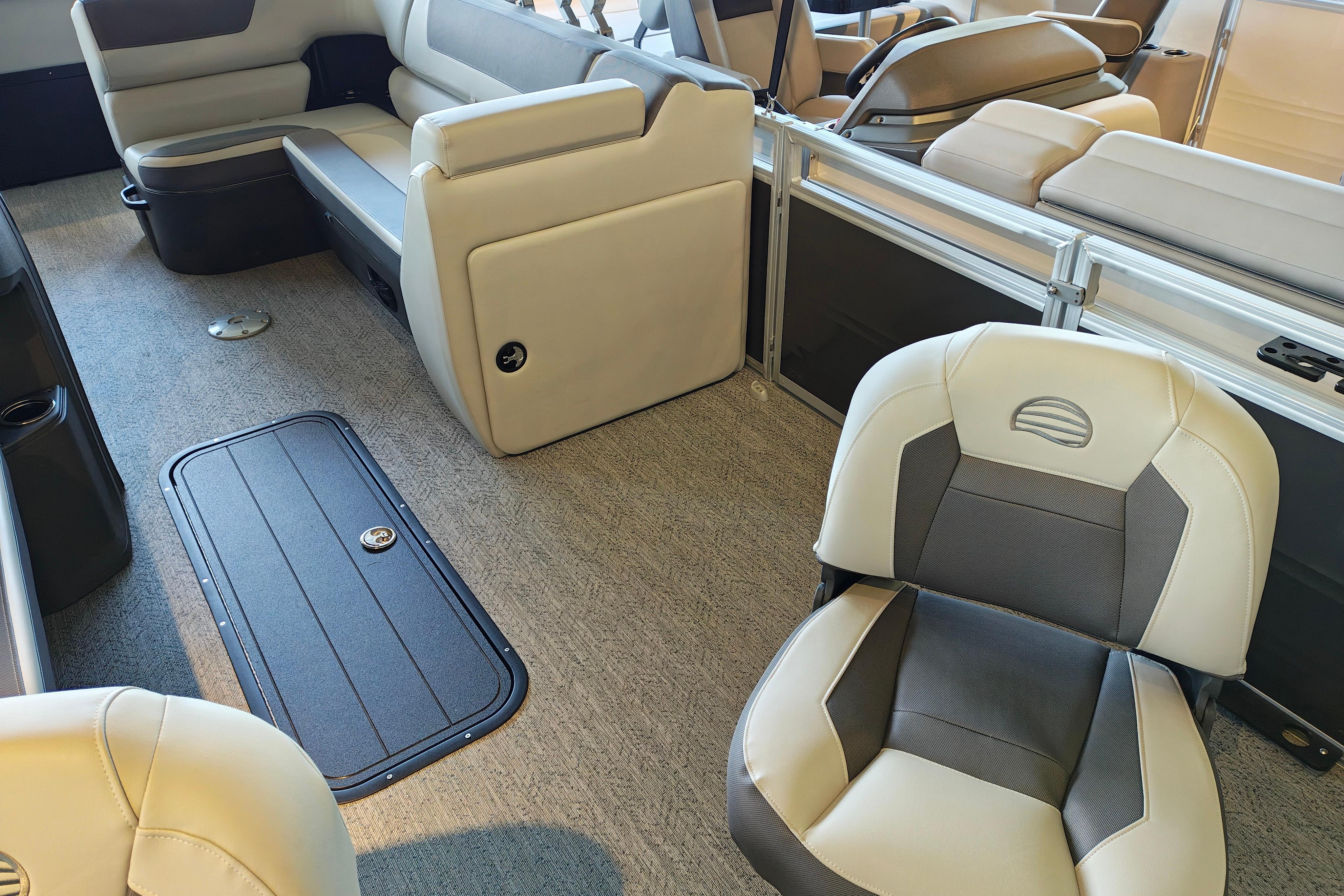 Interior of 2026 Sun Tracker Fishin' Barge 22 XP3, featuring comfortable seating and storage.