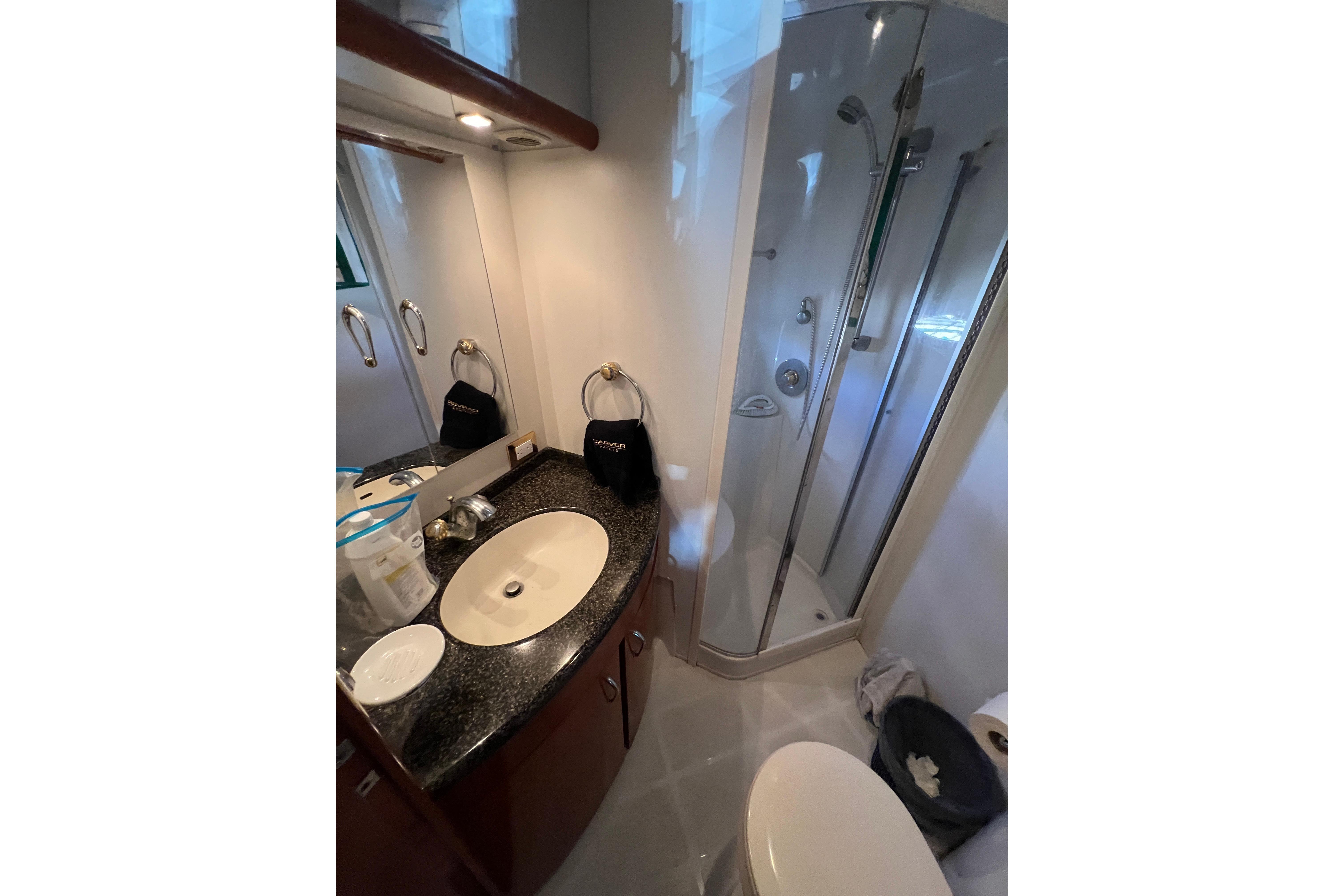 Luxurious bathroom in 2003 Carver 460 Voyager yacht with shower and vanity.