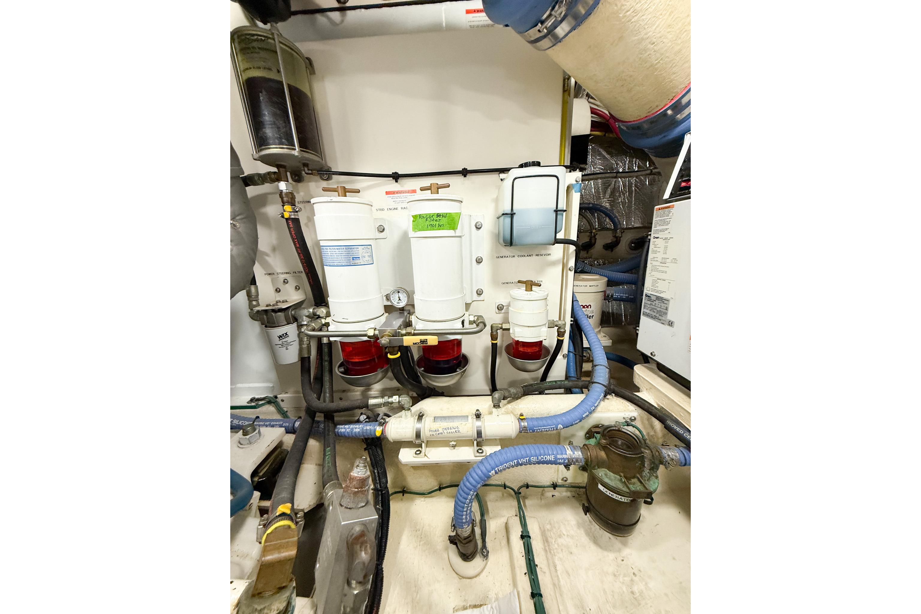 Engine room of 2007 Nordic Tug 54 with fuel filters and hoses.