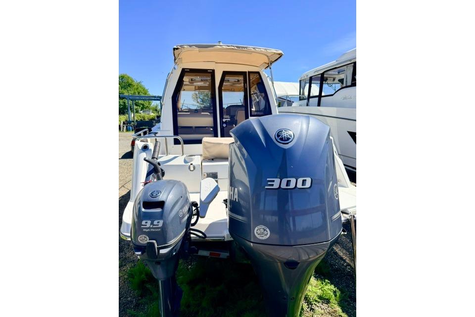 2017 Cutwater C-242 Coupe boat with dual Yamaha outboard motors, parked outdoors.