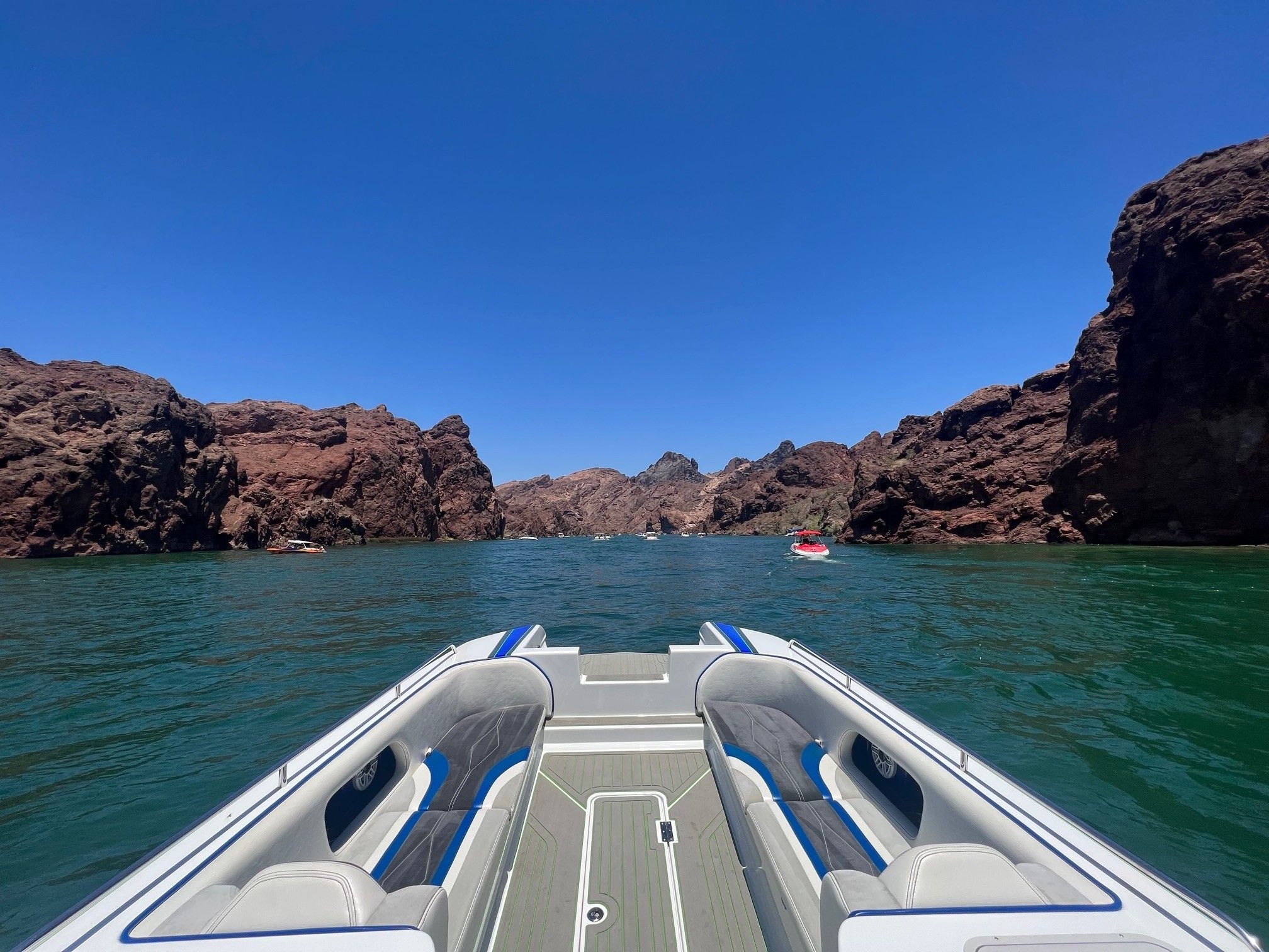 Custom Barron 290s boat on water between cliffs, 2021 model.