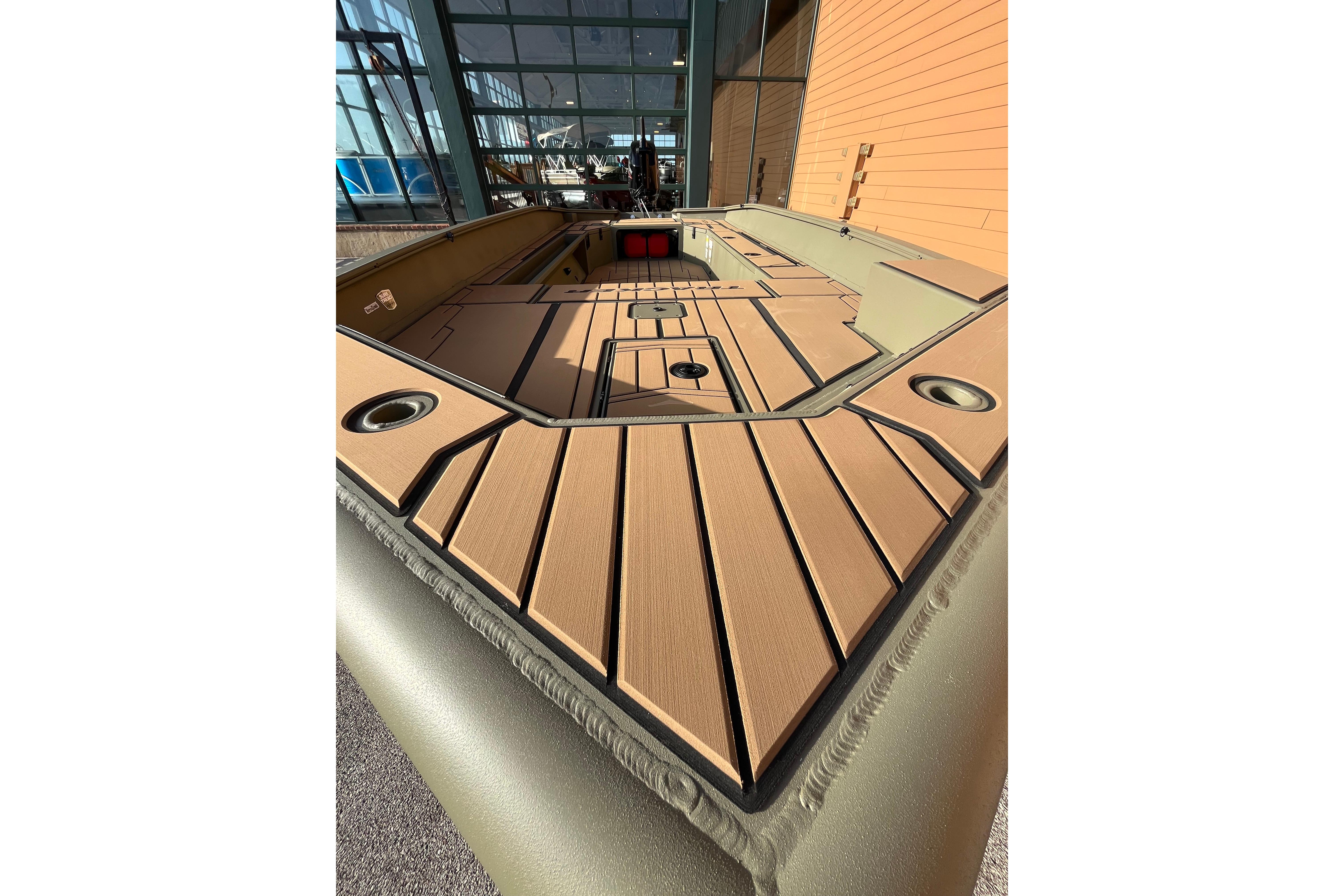 2026 Tracker Grizzly 1756 T Marsh boat interior with wood finish and cup holders.