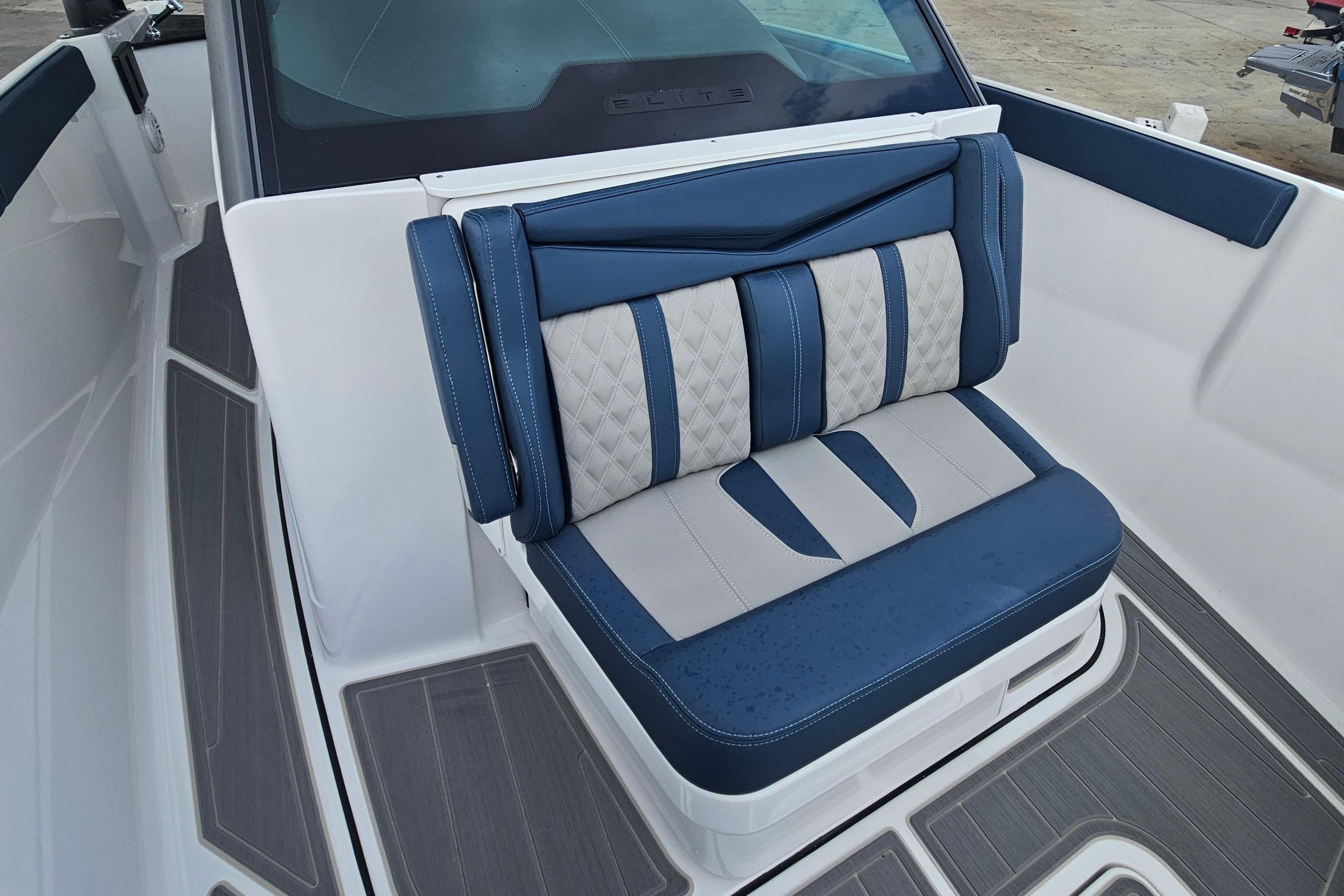 Luxurious seating on 2026 Monterey Elite 27 OB boat, featuring blue and gray upholstery.