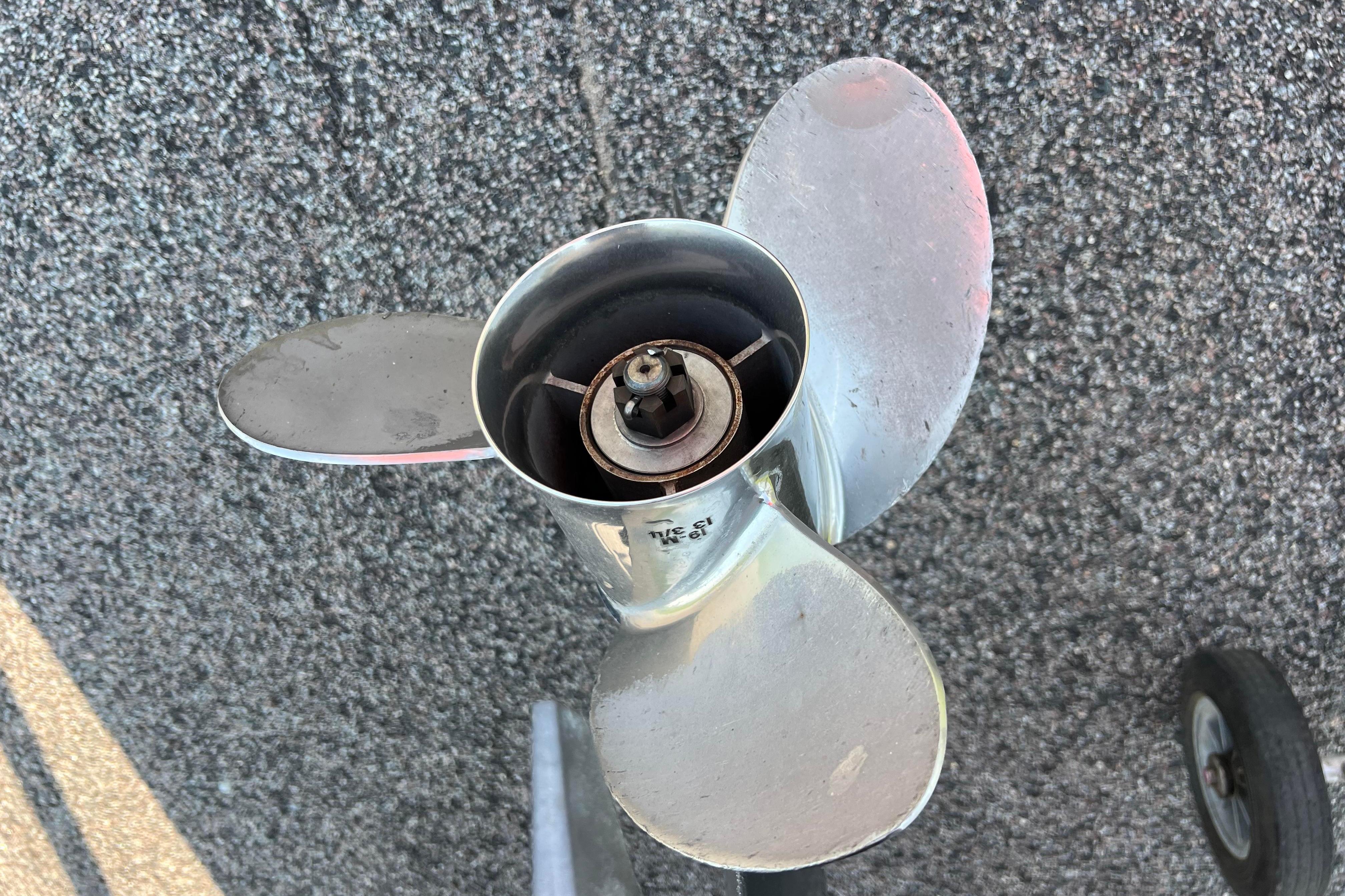 Propeller of a 2012 Sea Fox 206 Center Console boat on textured surface.