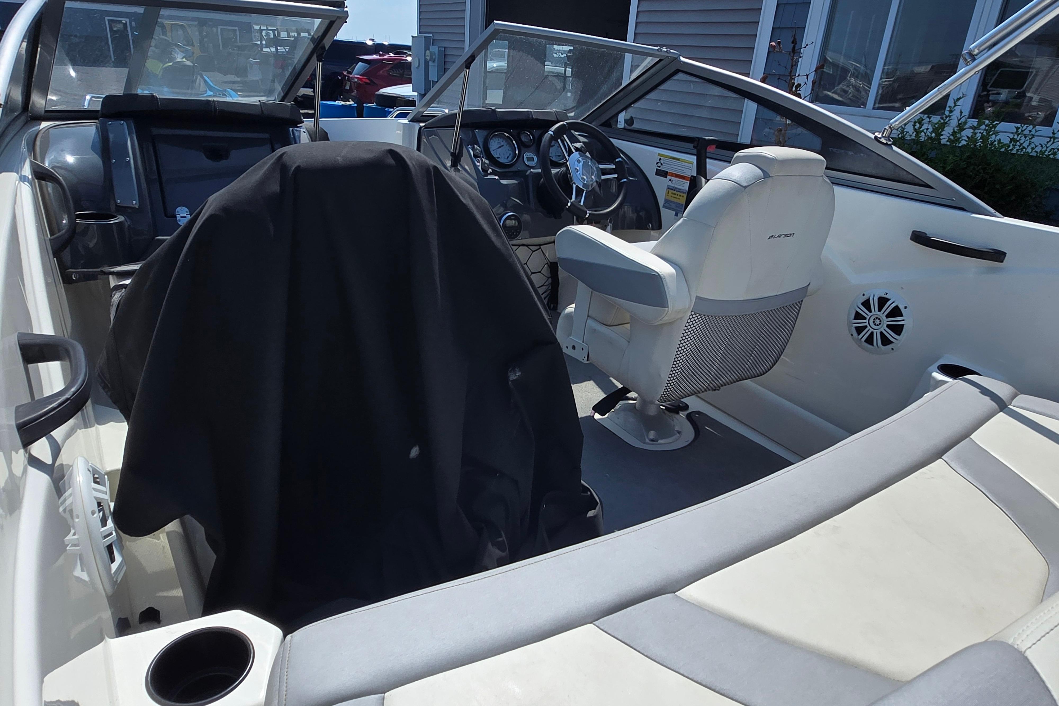 2014 Larson LX 195S IO boat interior with steering wheel and seating.