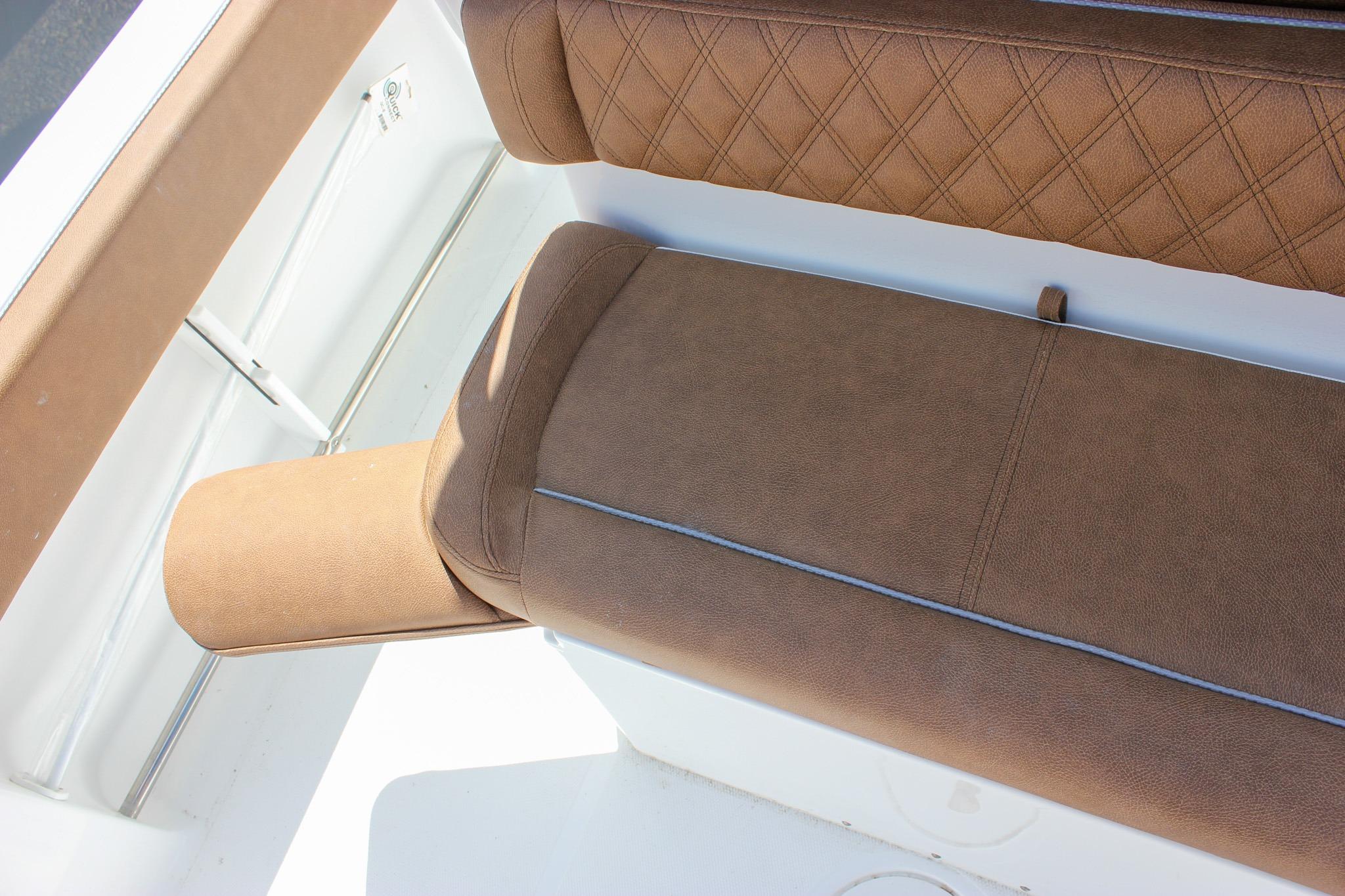 Brown cushioned seating on 2027 Sea Hunt Ultra 234 boat, featuring diamond stitching.