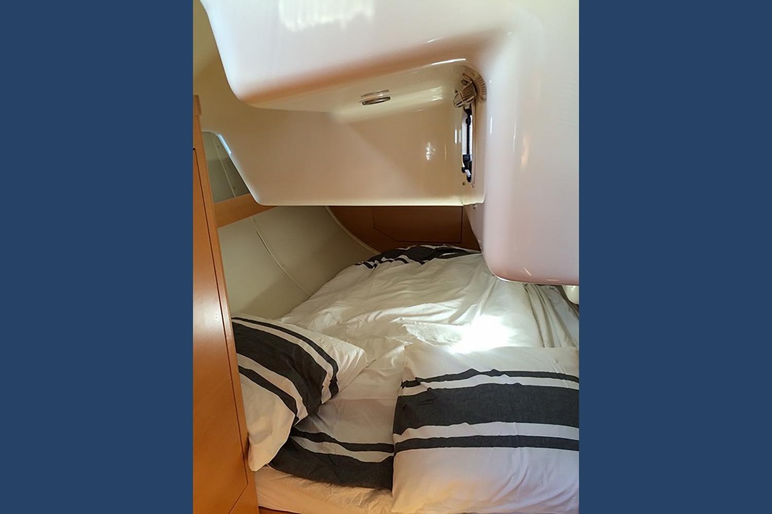 Cozy cabin interior of 2008 Elan Marine ELAN 450 yacht with striped bedding.