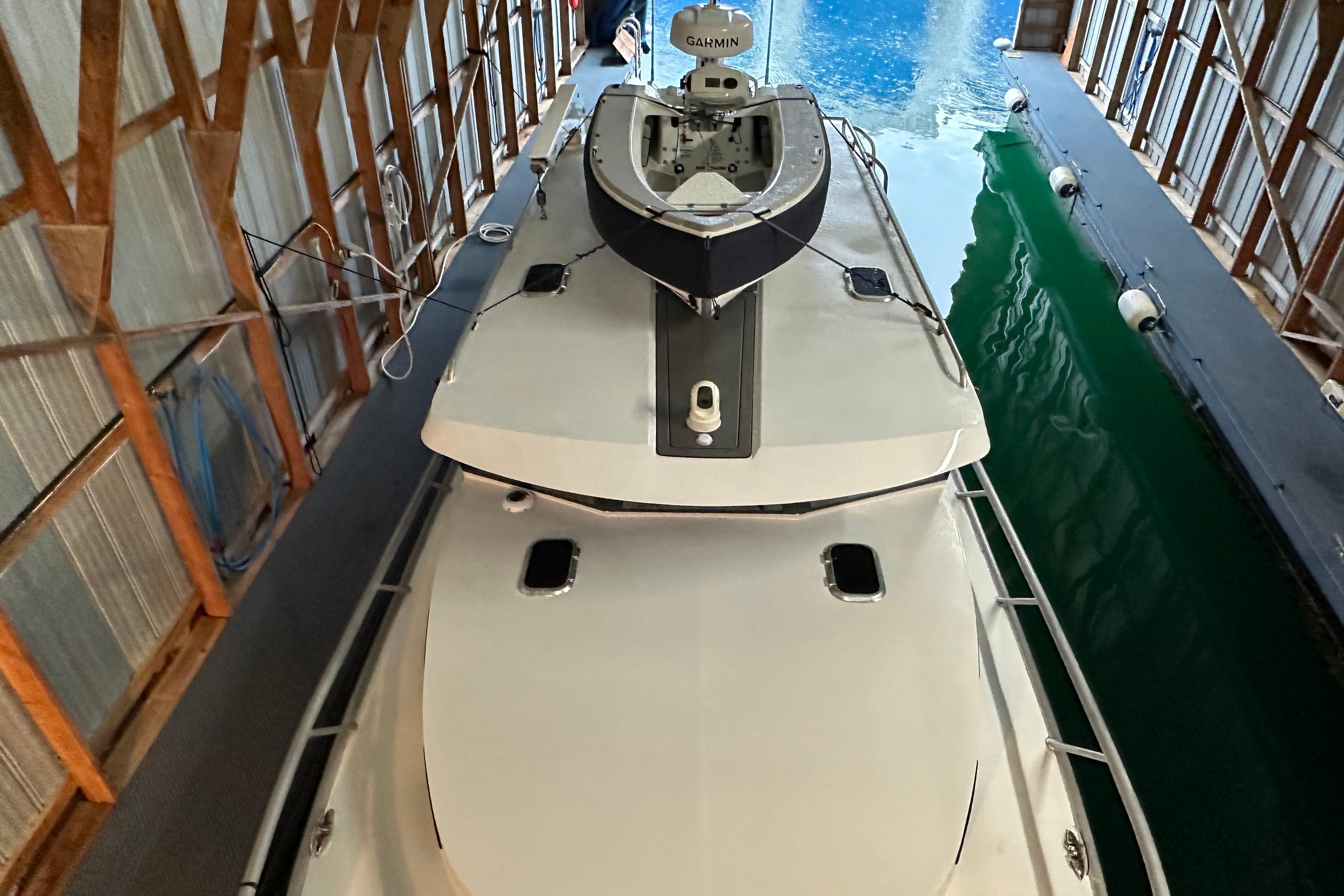 2024 Herley 11 Explorer boat docked in a covered marina, top view.