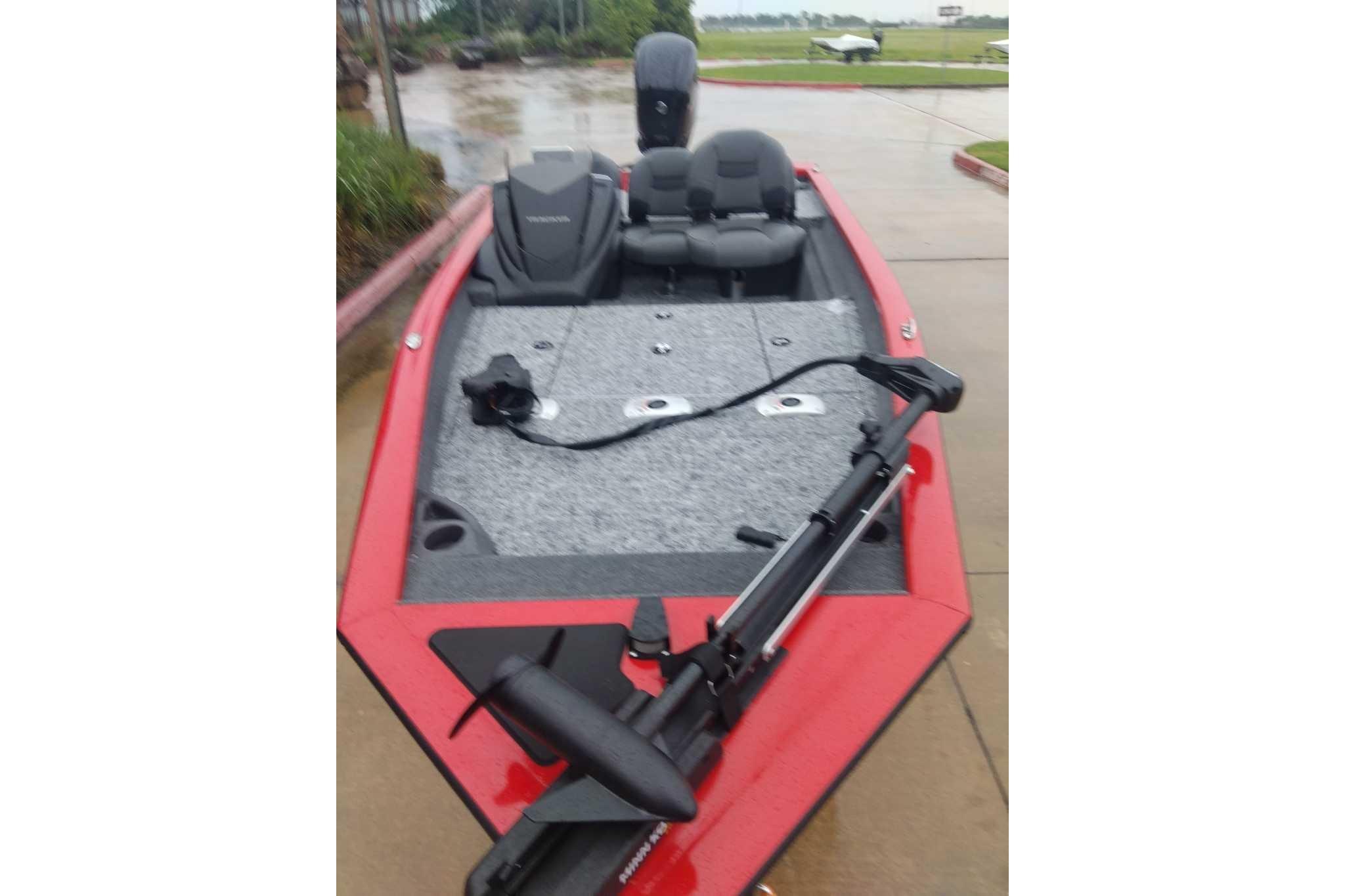 2026 Tracker Pro Team 175 Crappie Edition boat, red exterior, parked on wet pavement.