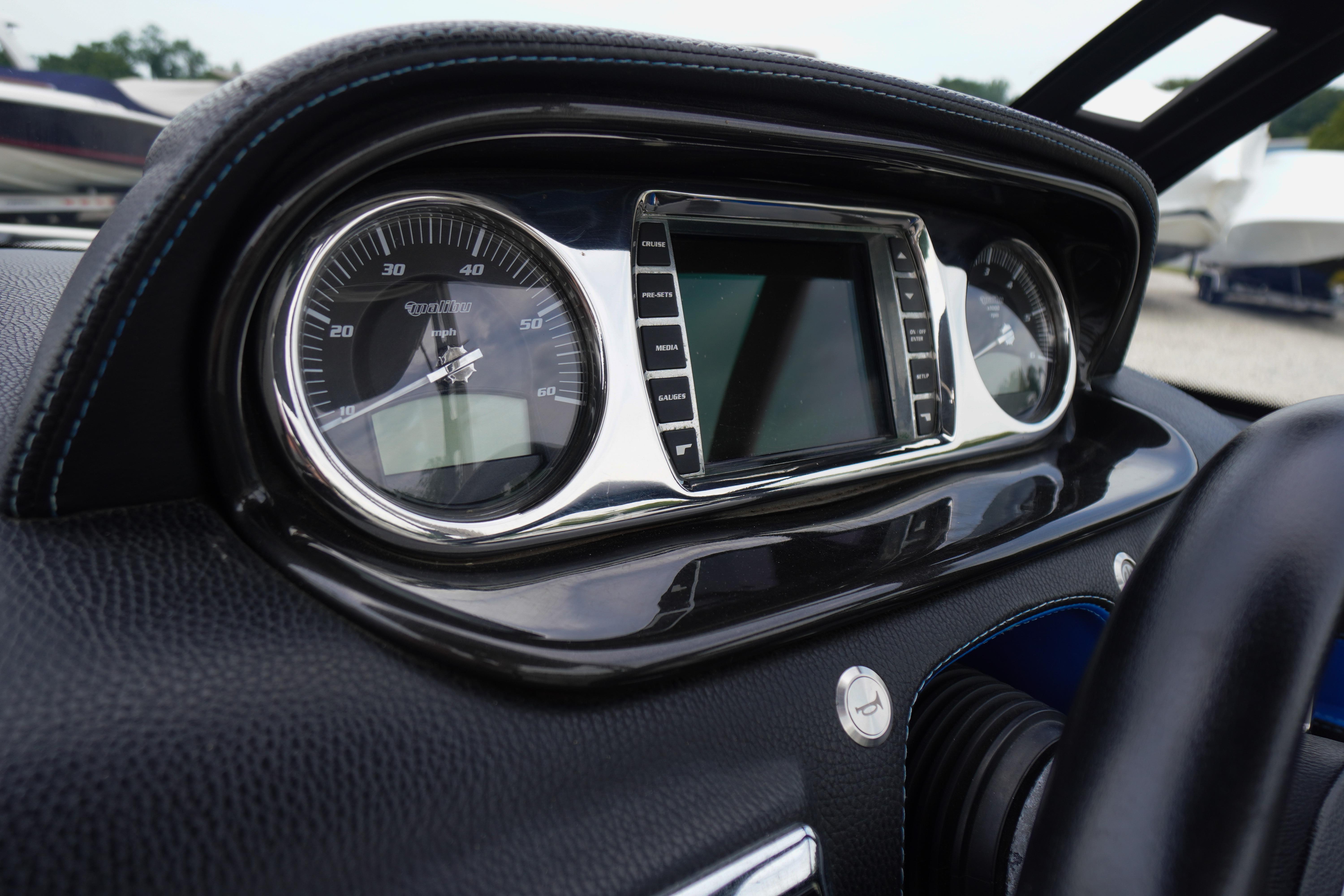 Dashboard of a 2011 Malibu Wakesetter 21 VLX boat with speedometer and digital display.