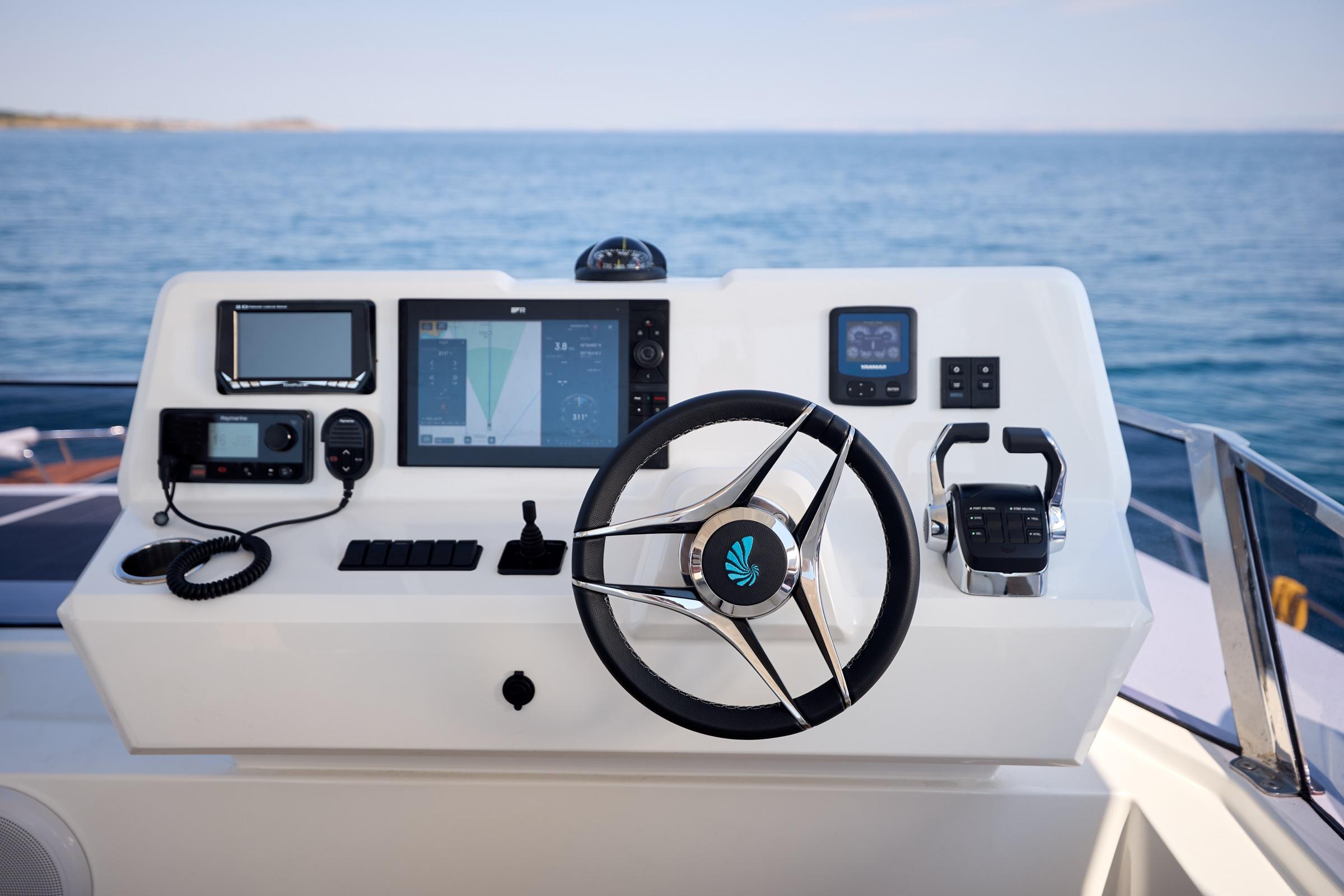Helm of 2025 Custom Omaya 50 Power Catamaran with modern navigation equipment.
