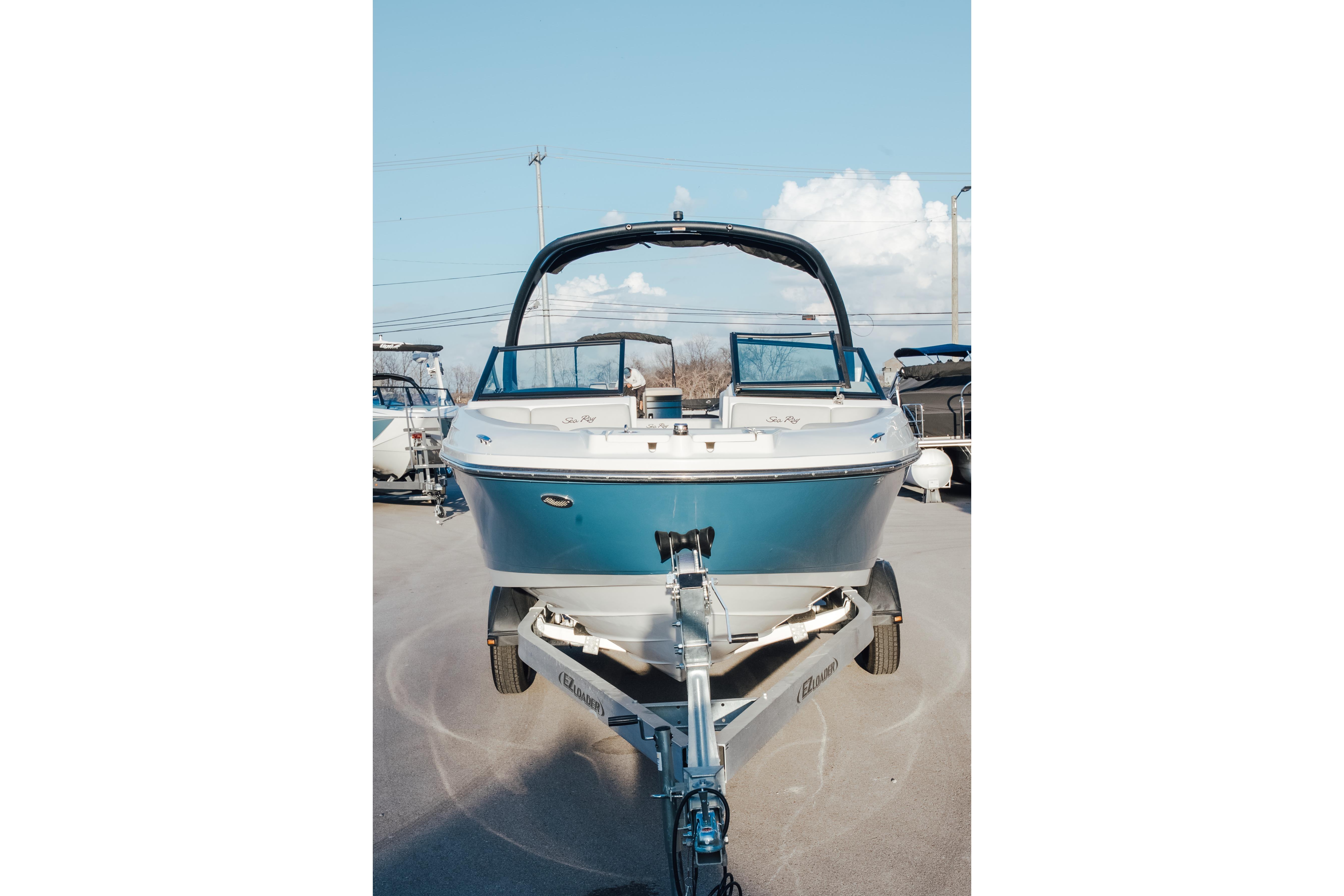 2023 Sea Ray SPX 230 boat on trailer, front view under clear sky.