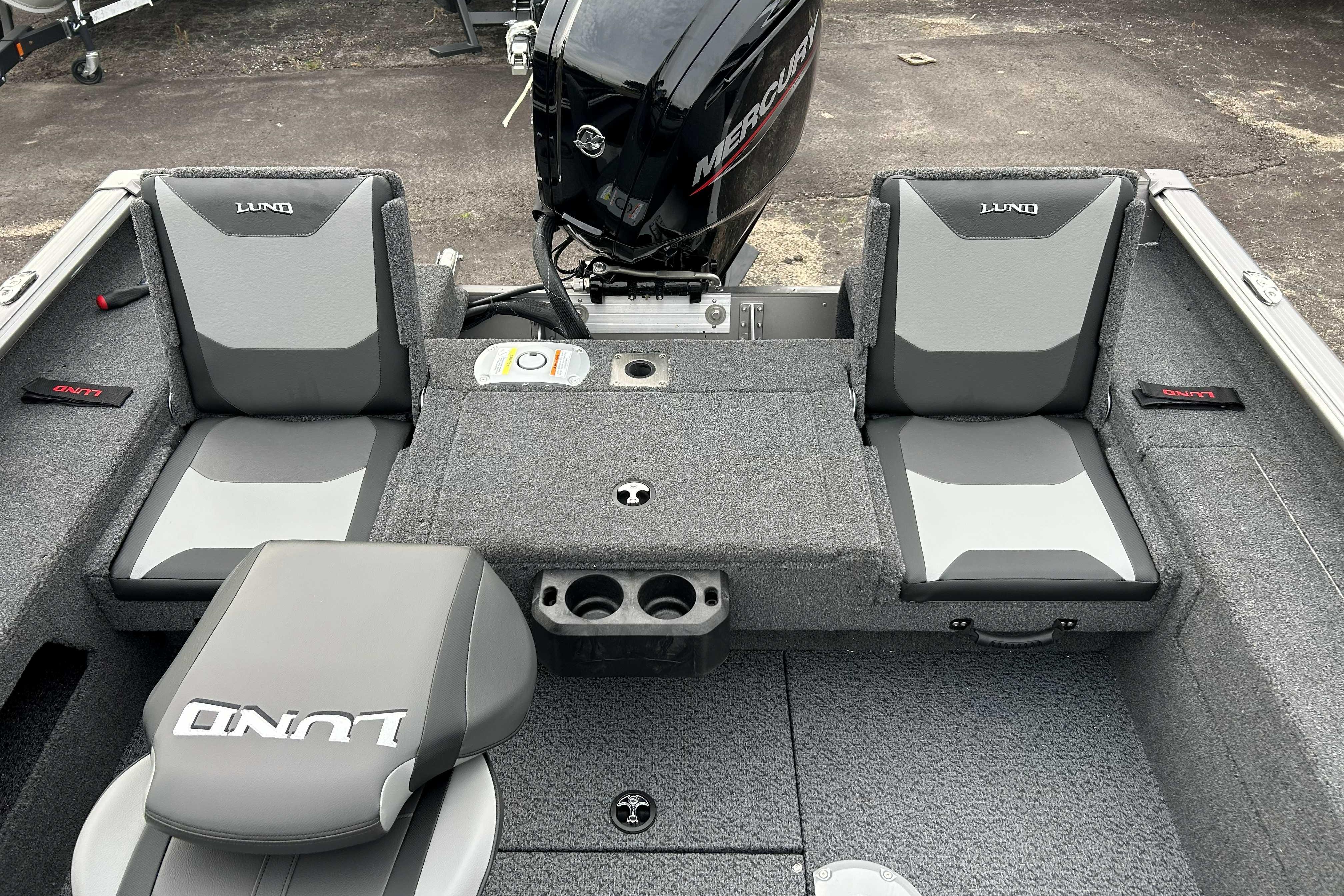 2027 Lund 1775 Impact XS boat interior with gray seating and Mercury engine.