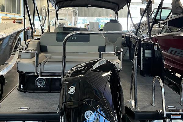 2024 Princecraft Quorum 23 RL pontoon boat interior with seating and motor.