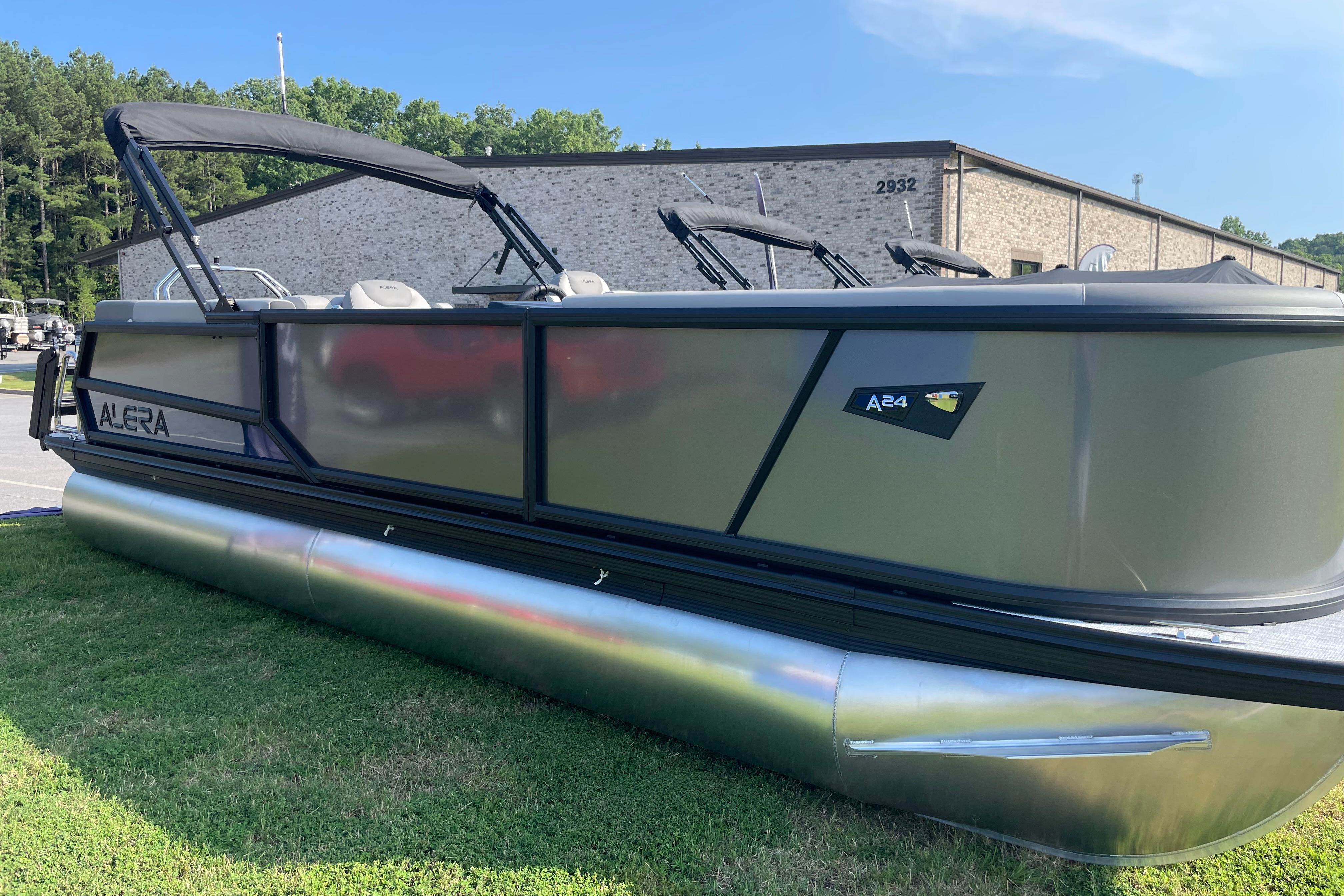 2027 Alera A24 pontoon boat displayed outdoors on grass.