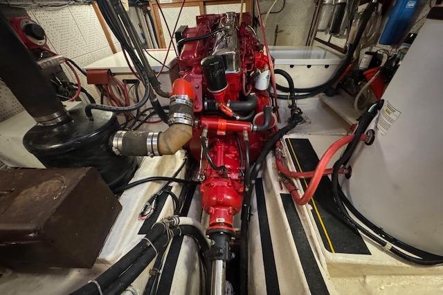 Engine room of a 1986 Krogen 42 Classic, featuring a red marine engine.
