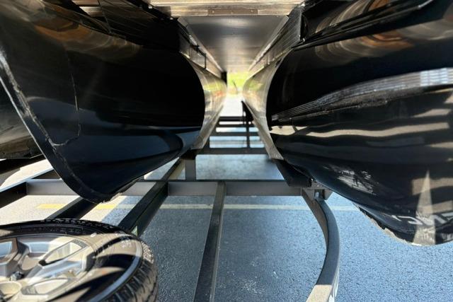 Underneath view of a 2025 Regency 250 DL3 pontoon boat on a trailer.