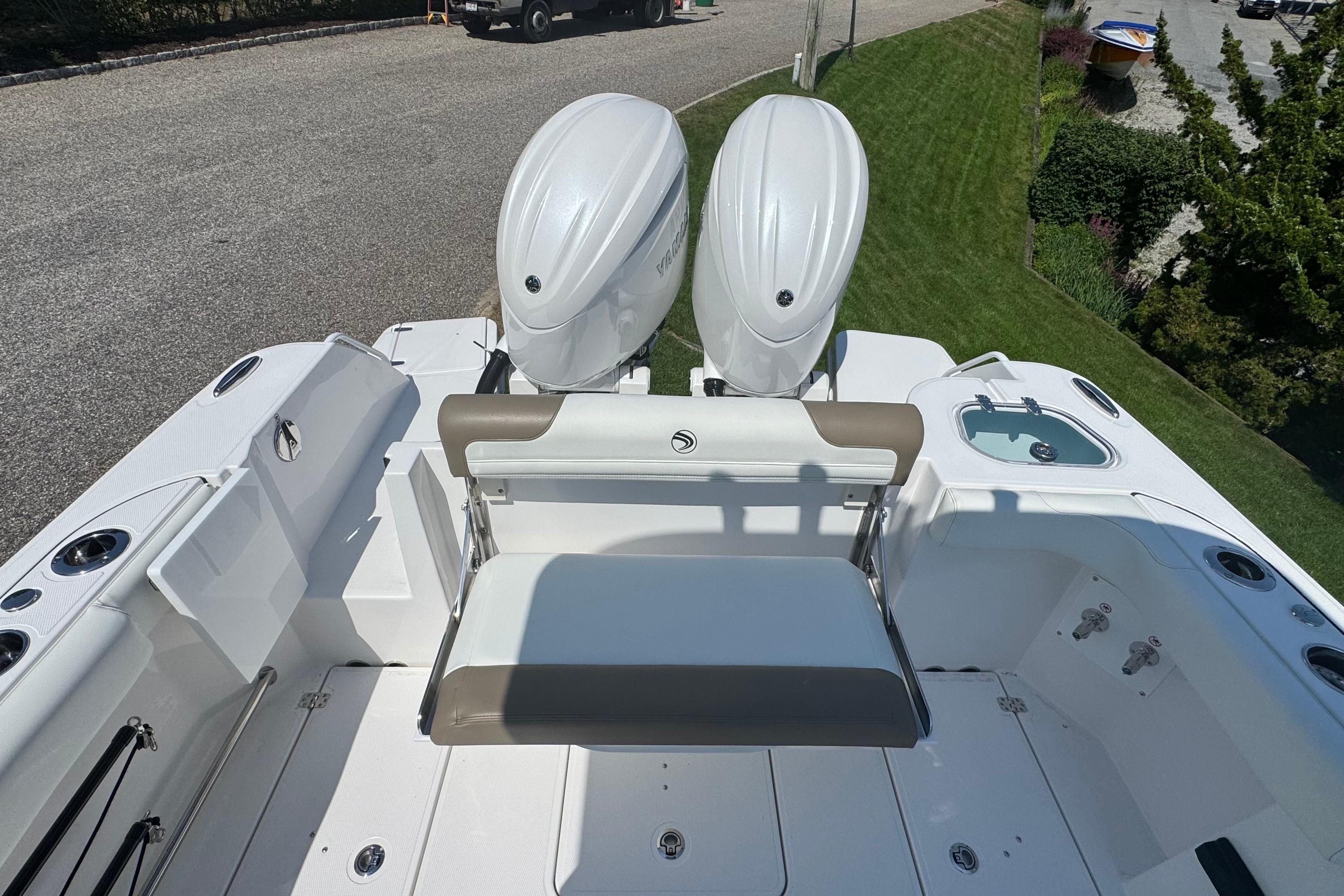 2026 Edgewater 250CC boat with dual outboard engines, spacious deck, and seating area.