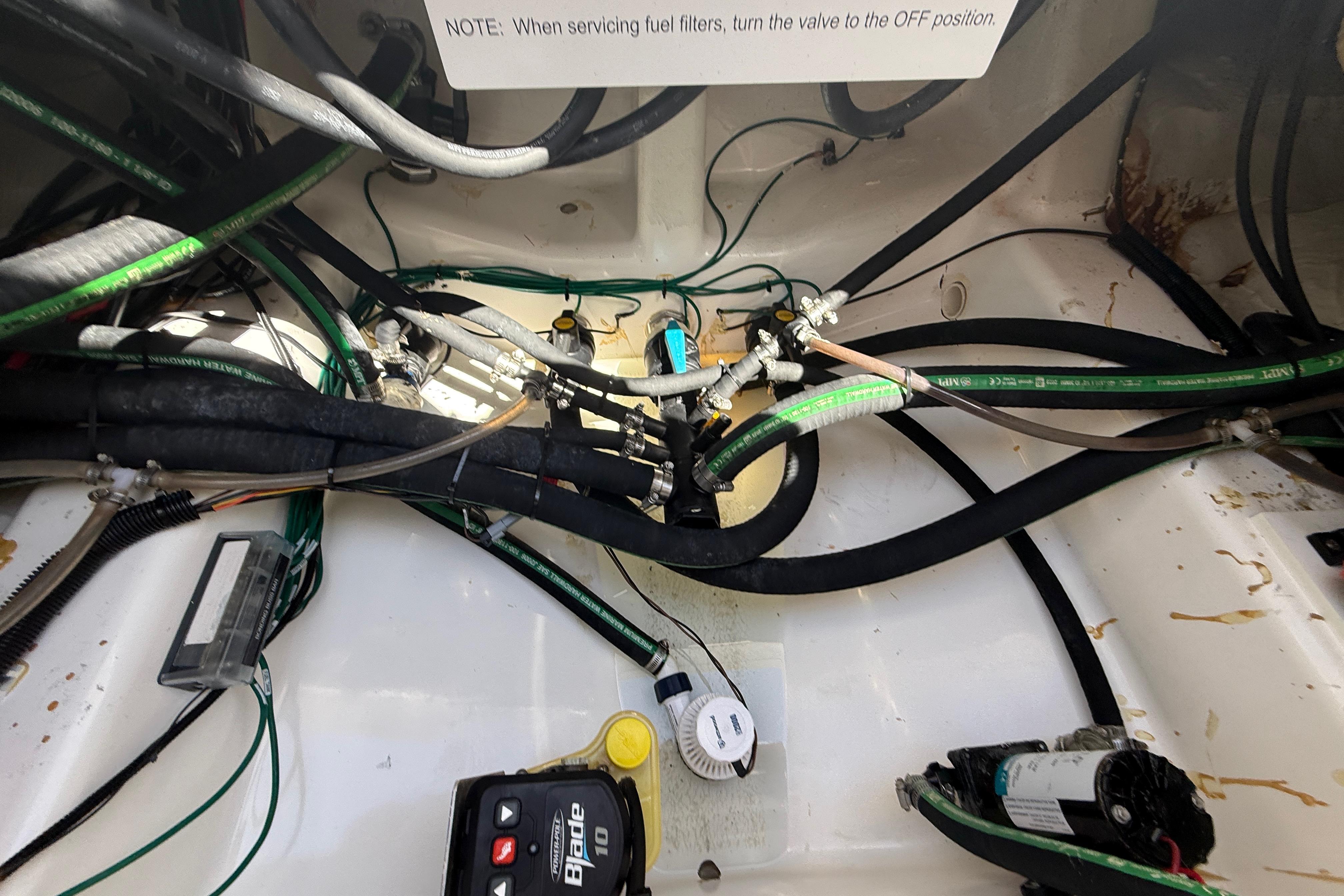 2024 Caymas 281 HB boat engine compartment with hoses and wiring.