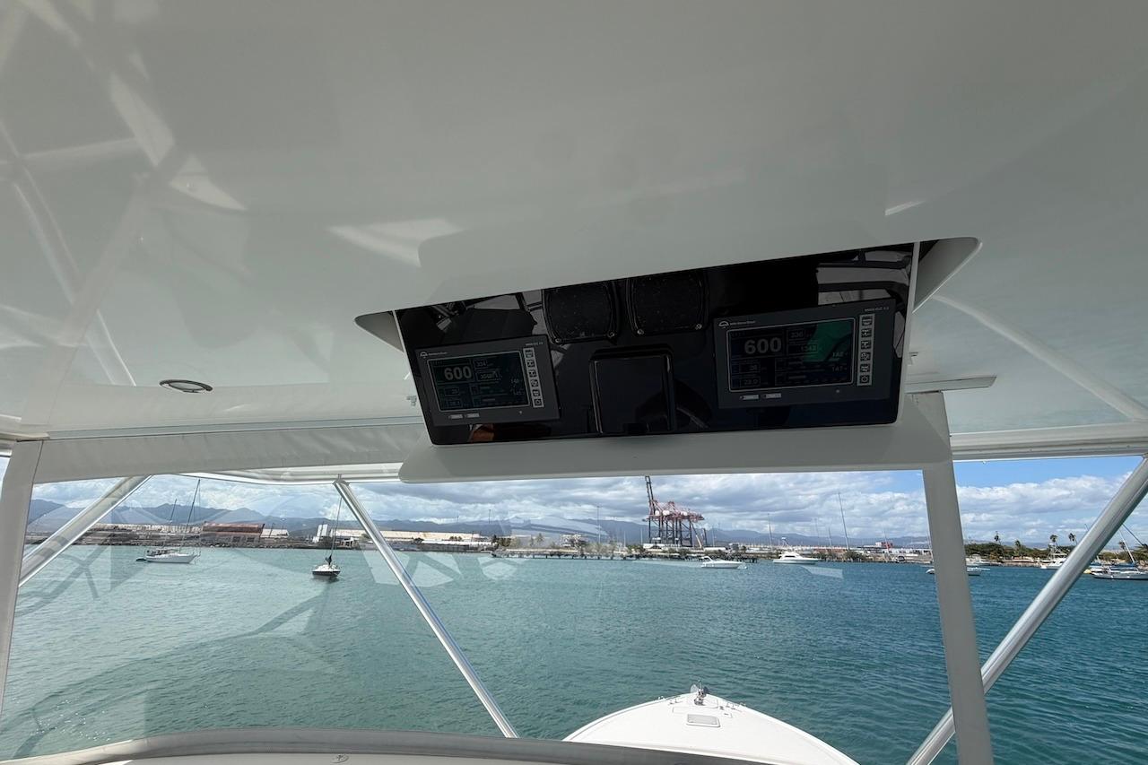 Interior view of 2012 Viking 50 Convertible yacht with navigation equipment and ocean backdrop.