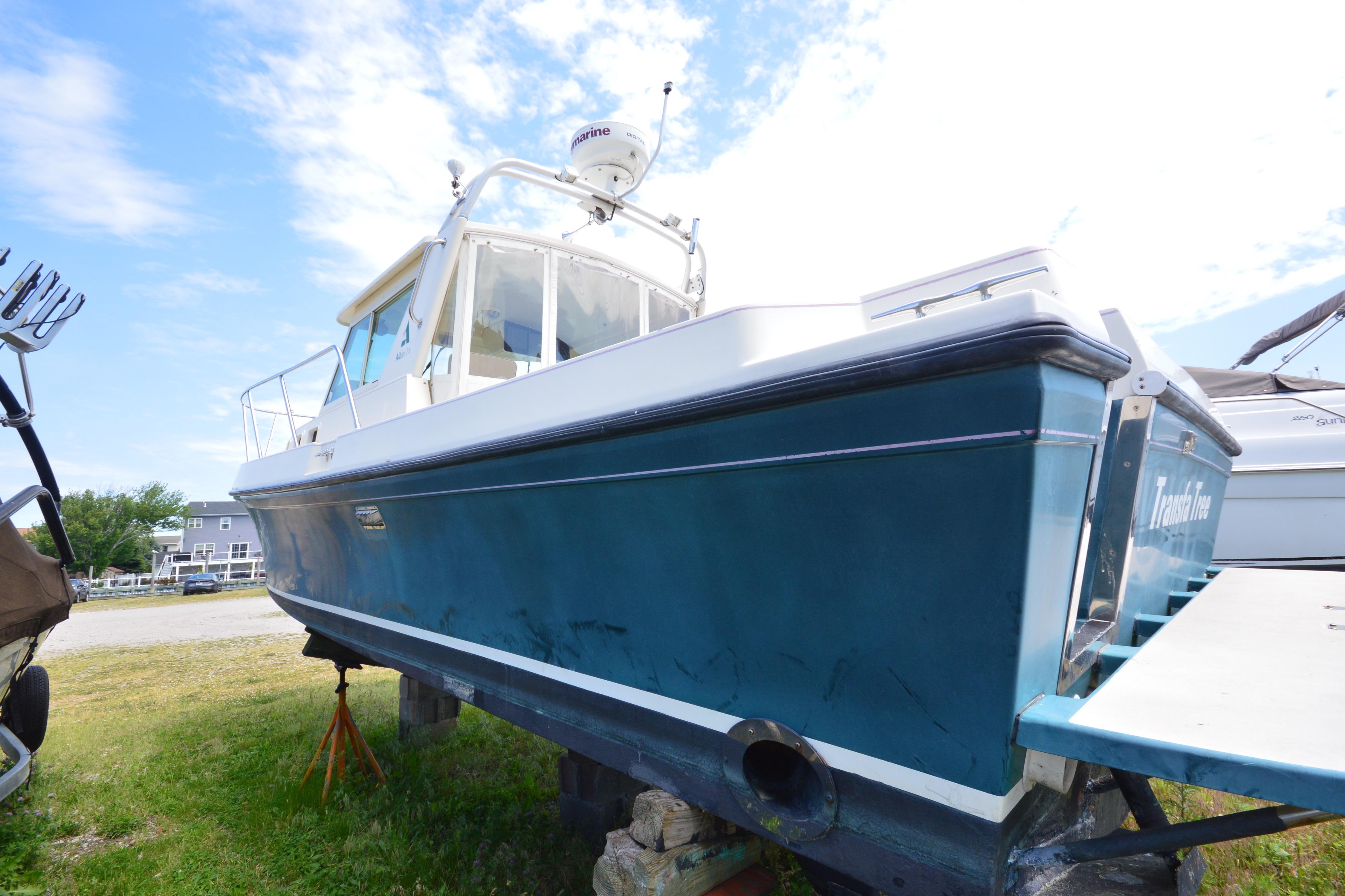 2001 Albin 28 Tournament Express boat on land, blue hull, clear sky background.