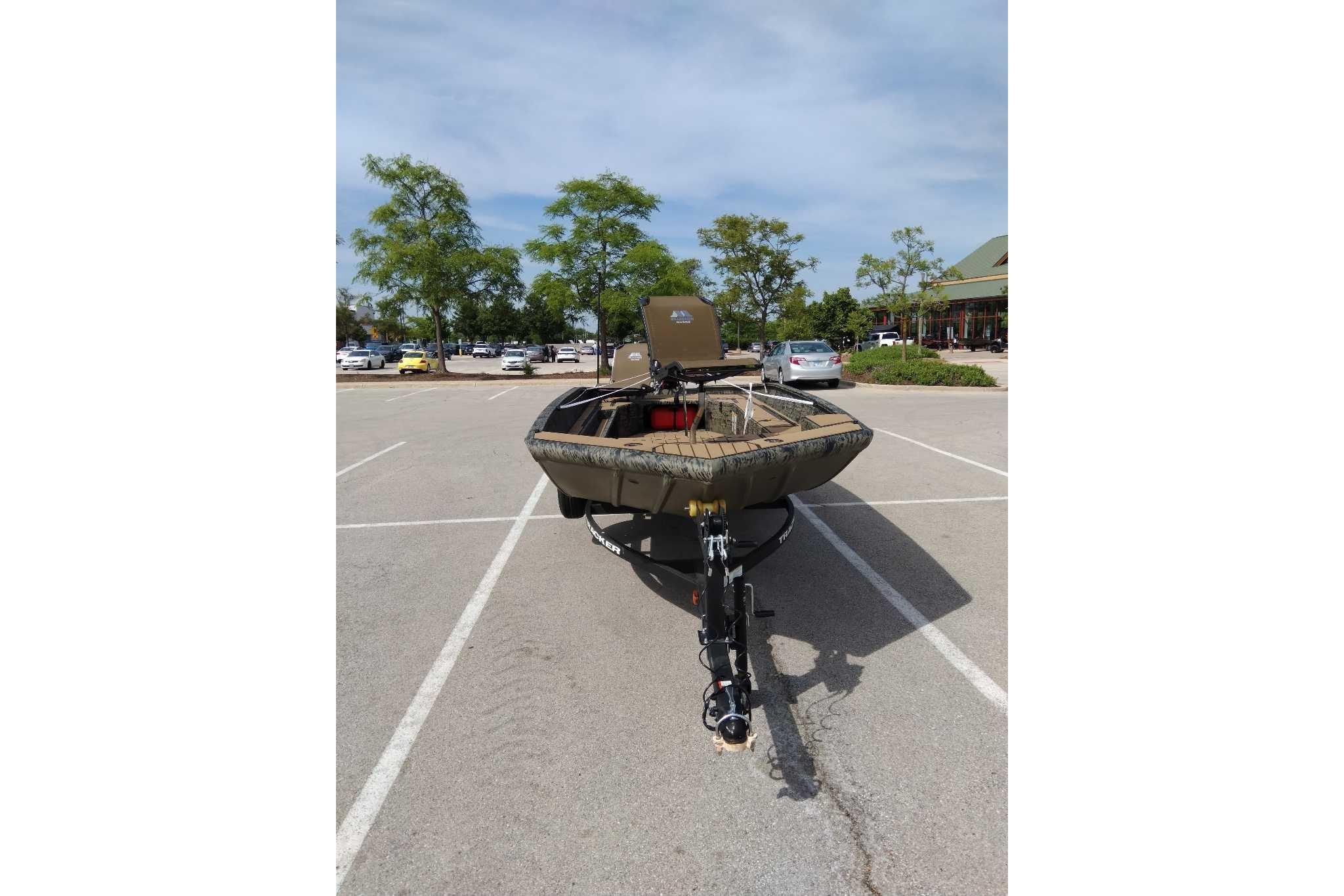 2026 Tracker Grizzly 1756 T Marsh boat parked in a sunny parking lot.