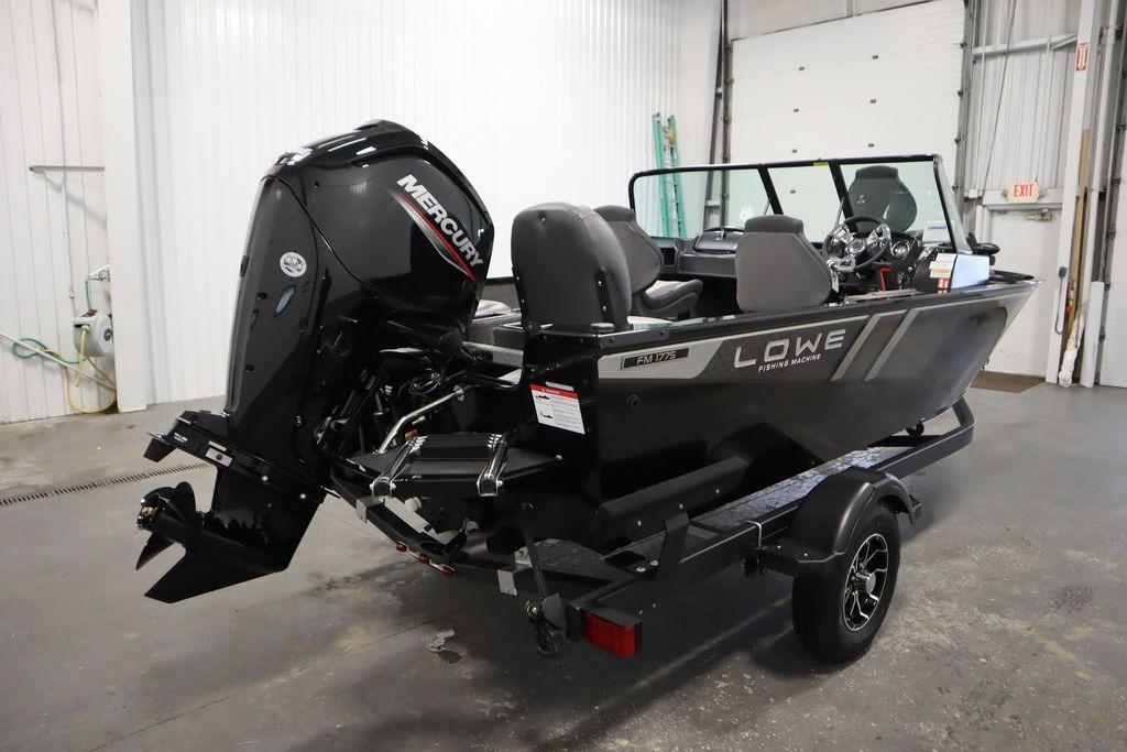 2026 Lowe Fishing Machine 175 boat with Mercury engine in a garage setting.